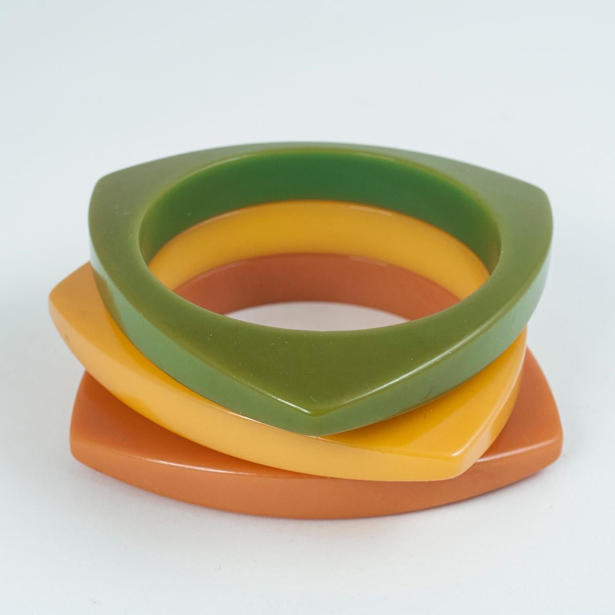 Three early to mid-20th century Bakelite bangle bracelets

A trio of triangular bakelite bangles in avocado, mustard and mango, with beautiful patina from age and use. They measure 8