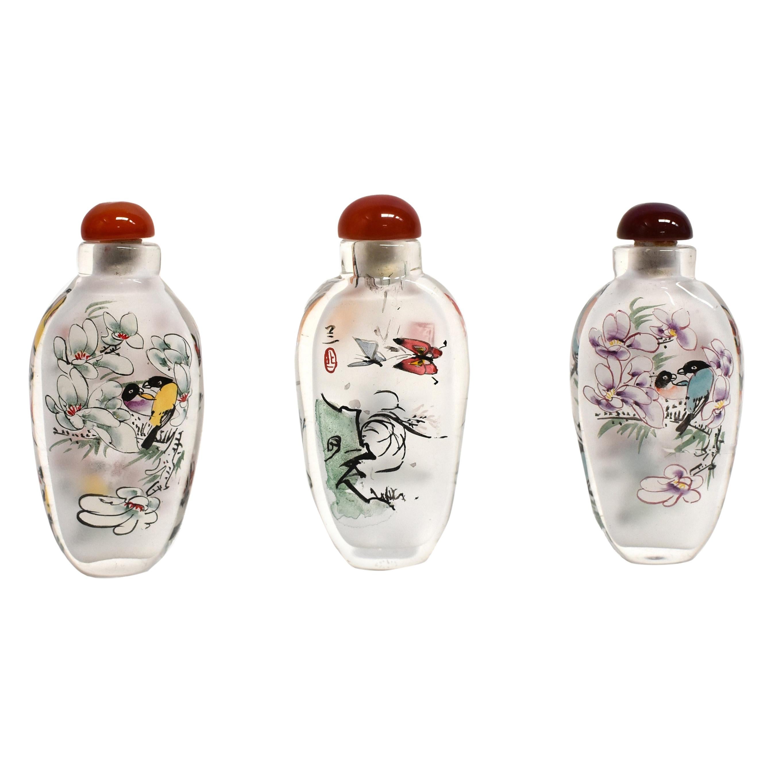 Three Églomisé Reverse Painted Snuff Bottles with Magnolia and Orchid For Sale