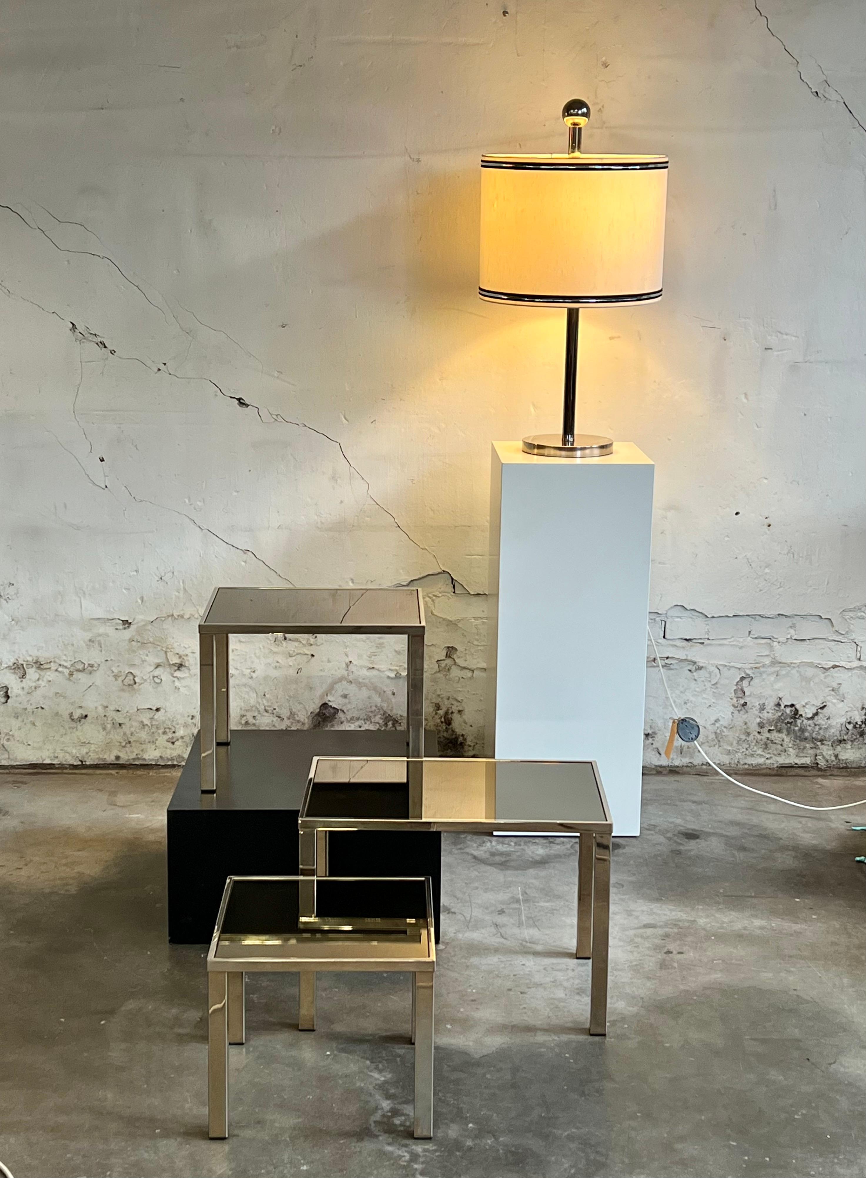 A set of nesting tables by the Belgian manufacturer Belgochrom. Functional yet elegant. Originally gold plated, they lost a part of the gold plating due to age and use. This gives them a particular interesting patina with their silvery and golden