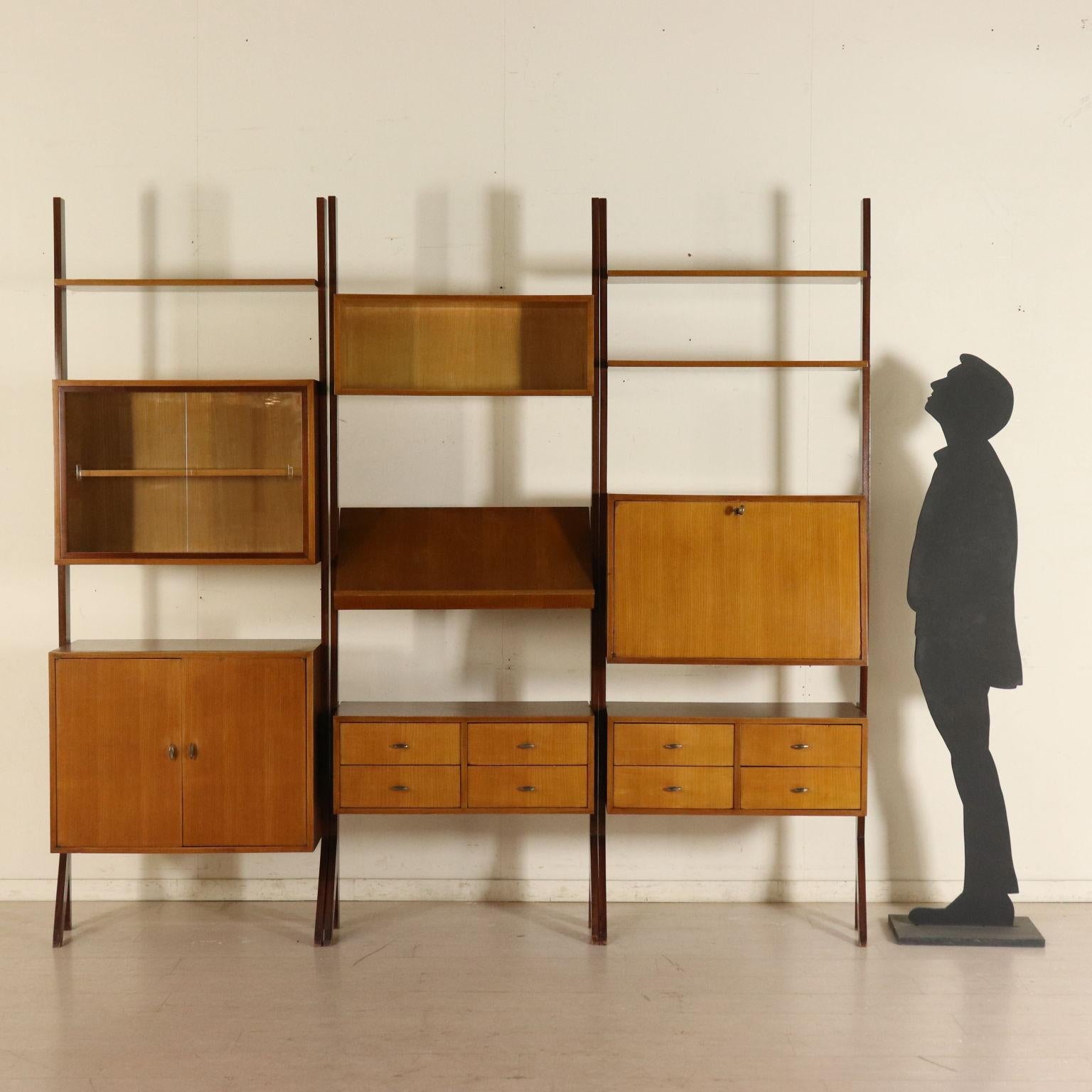 A three elements bookcase with glass sliding doors, oak veneer, stained solid wood uprights. Manufactured in Italy, 1960s.