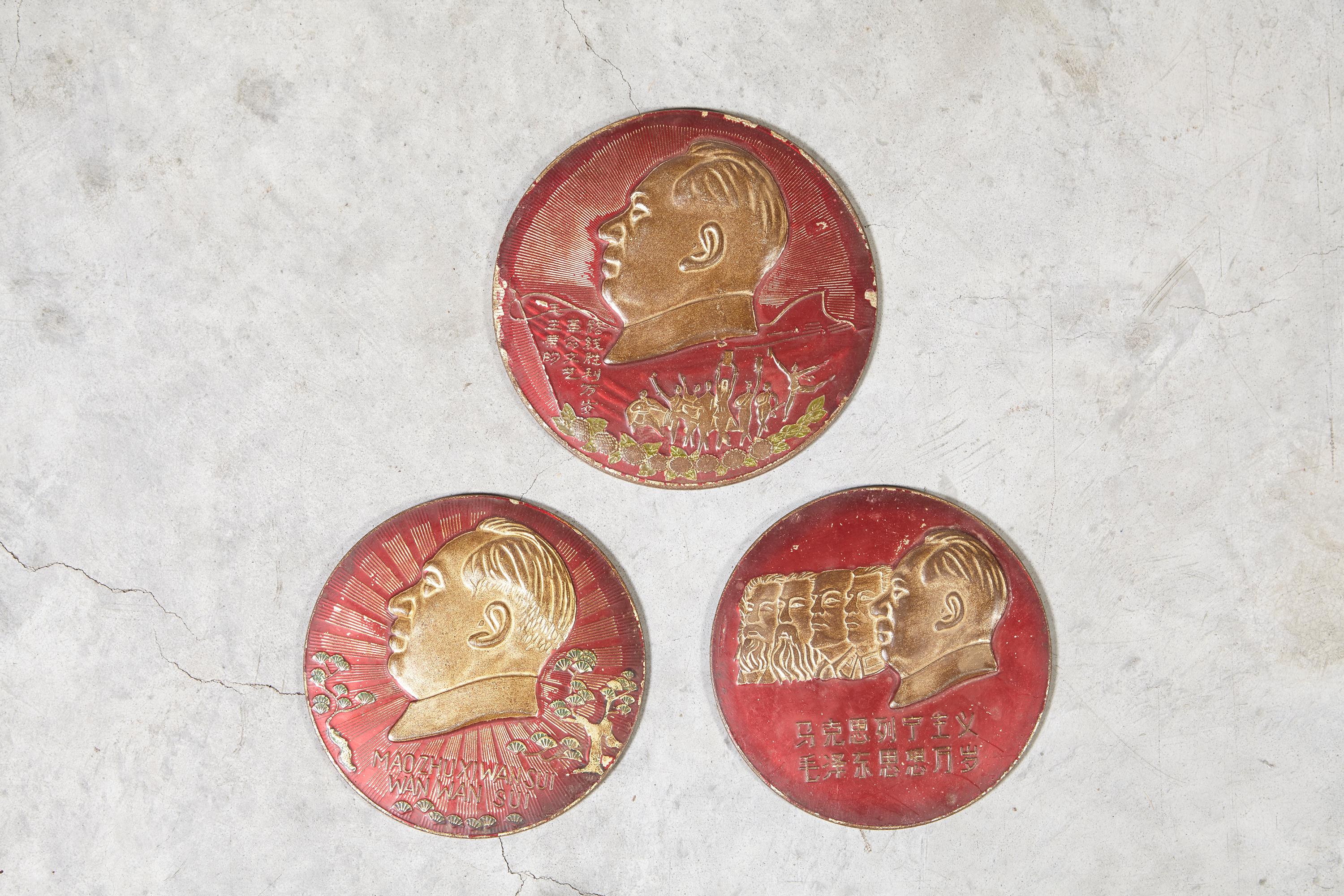 Three cultural revolution period embossed metal plaques, each with the image of Chairman Mao, one plaque also including images of the leaders of Russian communism. 
Priced and sold separately.

 