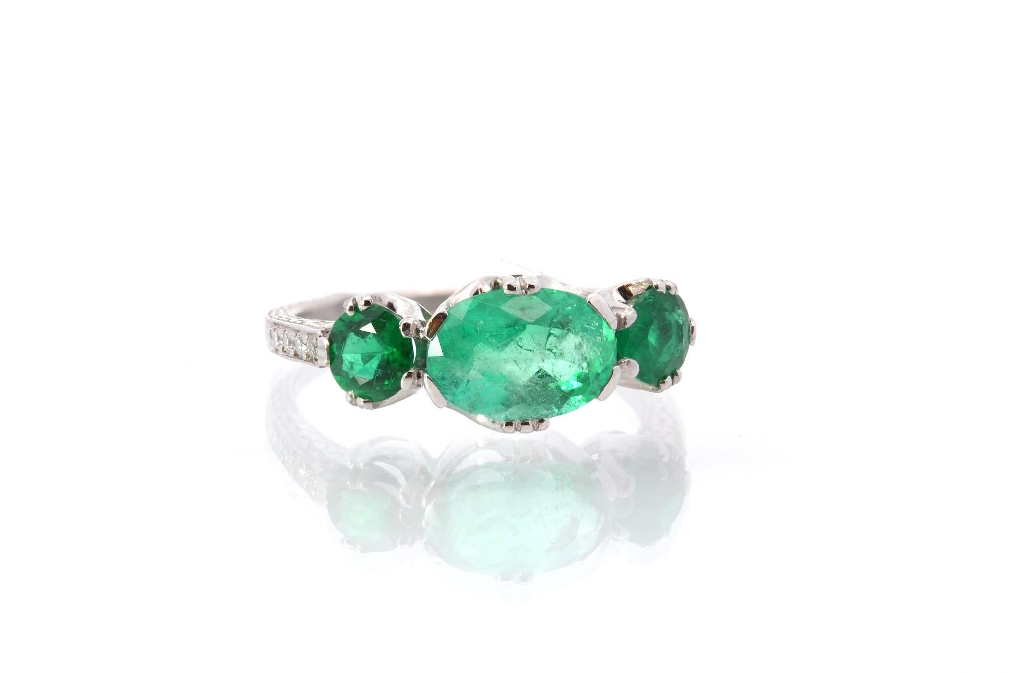 Oval Cut Three emeralds and diamonds ring in platinum