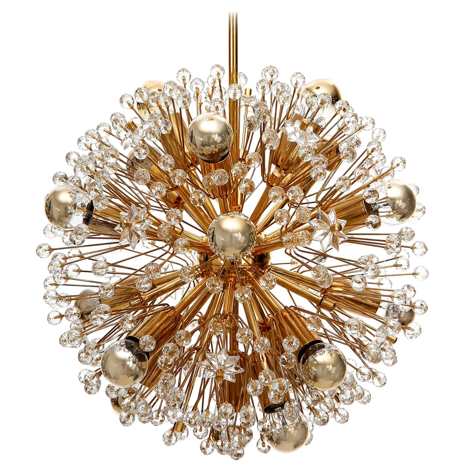 One of three Sputnik chandeliers designed by Emil Stejnar and manufactured in midcentury, circa 1970.
This beautiful light fixture is made of a 24-carat gold-plated brass frame which is decorated with cut glass in the form of beads and stars. This