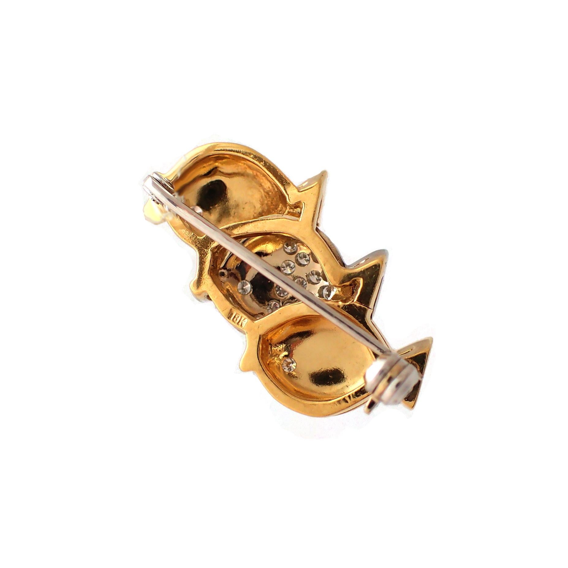 This fun fish pin consists of two yellow gold fishes flanking one pave diamond fish. Additional diamonds adorn each fish's tail and eyes. This pin contains 0.36ct of diamonds (G-H color, VS clarity). 