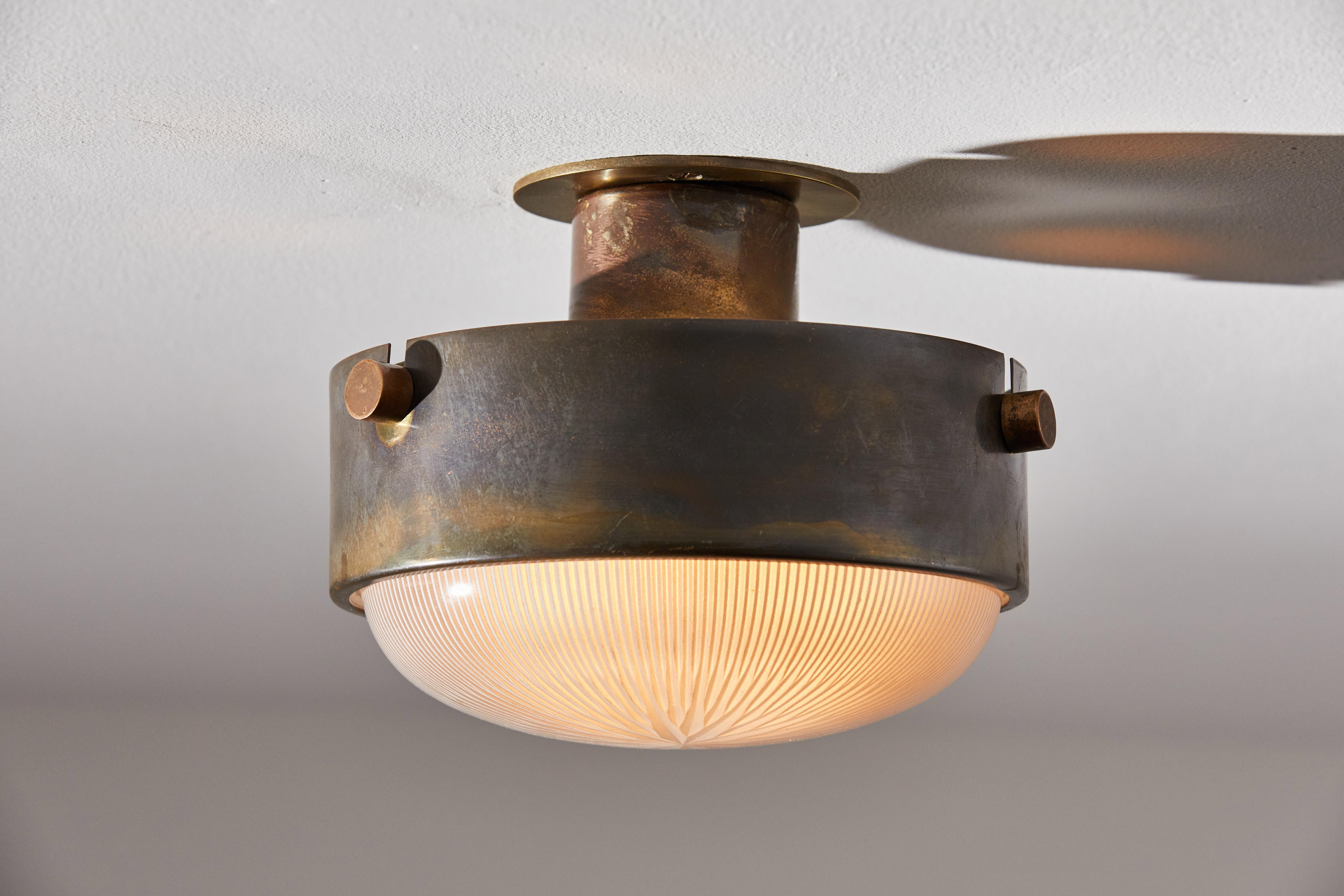 Three flush mount ceiling lights by Ignazio Gardella. Designed and manufactured in Italy, circa 1950s. Brass, Holophane glass. Rewired for U.S. junction boxes. Each light takes one E26 Edison 75w maximum bulb. Bulbs provided as a one time courtesy.