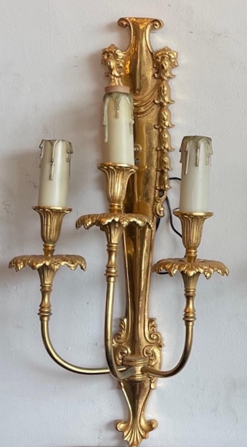 Here are 3 beautiful examples of French 19th century Louis XVI style gold plated bronze sconces with 3 candle lights each. They have been convevrted to electricity and are US wired. They are priced individually at $2,200 each but are priced at