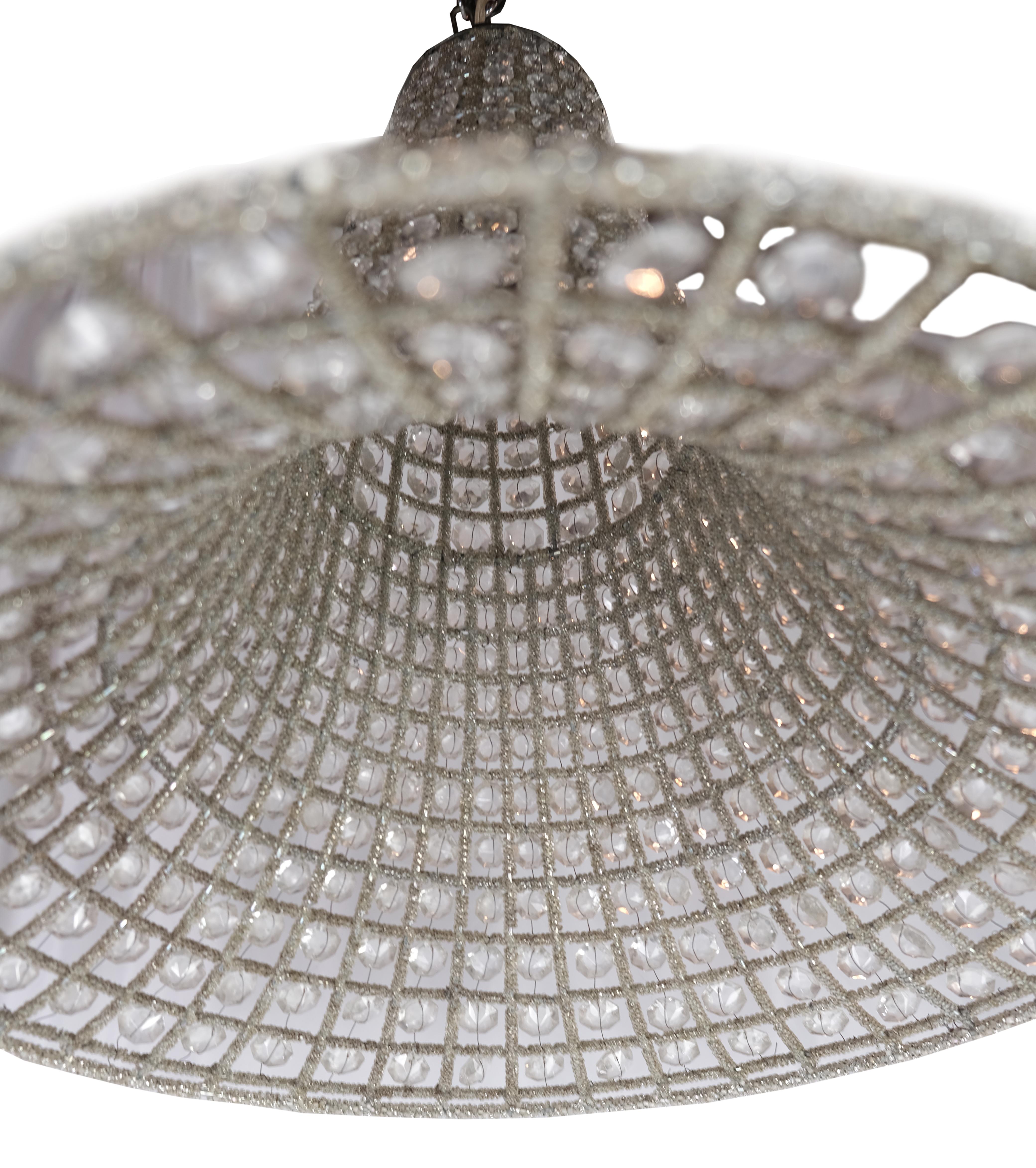 French bell shaped beaded glass and wire pendant chandeliers. We found these chic pendant lights in Paris. They are a great mix of Hollywood glamour and mid century modern streamline. Each light has a single standard socket. 
Priced individually.
