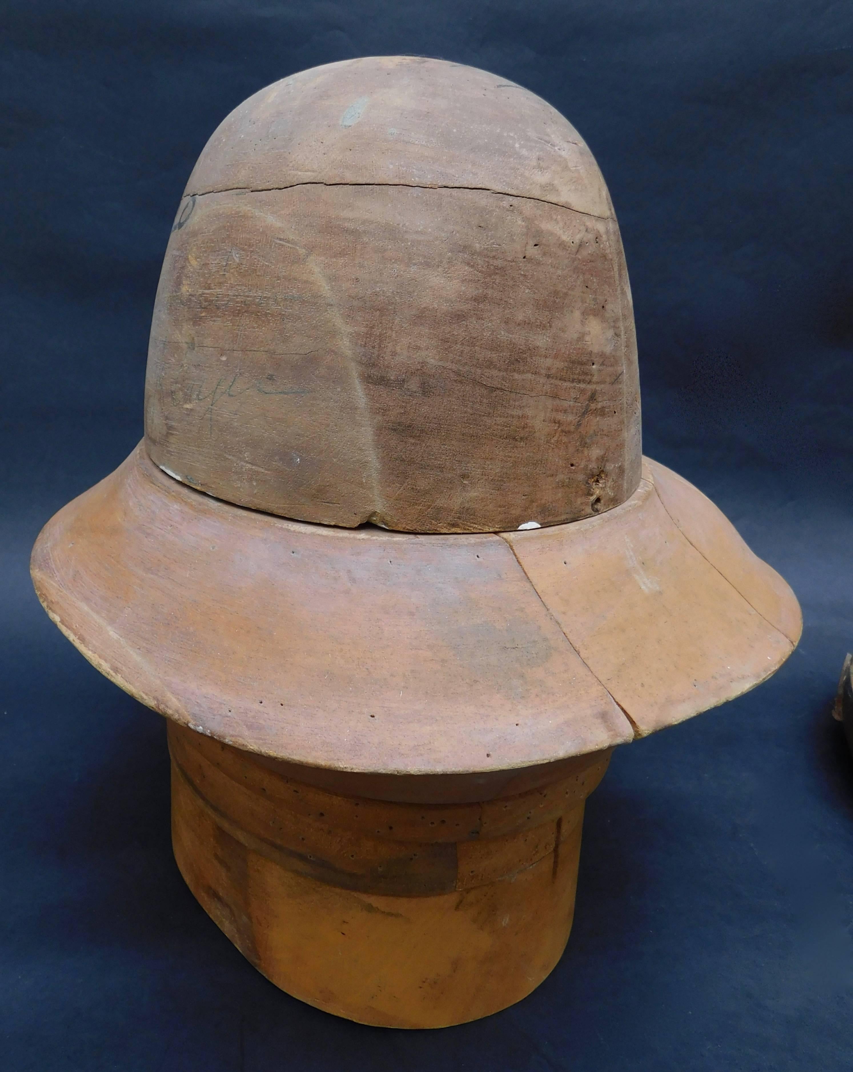 Very sculptural French wood hat block forms for making mens hats. 
Sold individually; please specify left middle or right hat block when ordering.

Straw or wool felt is tacked onto the wood form (notice the numerous holes) and then steamed and hand
