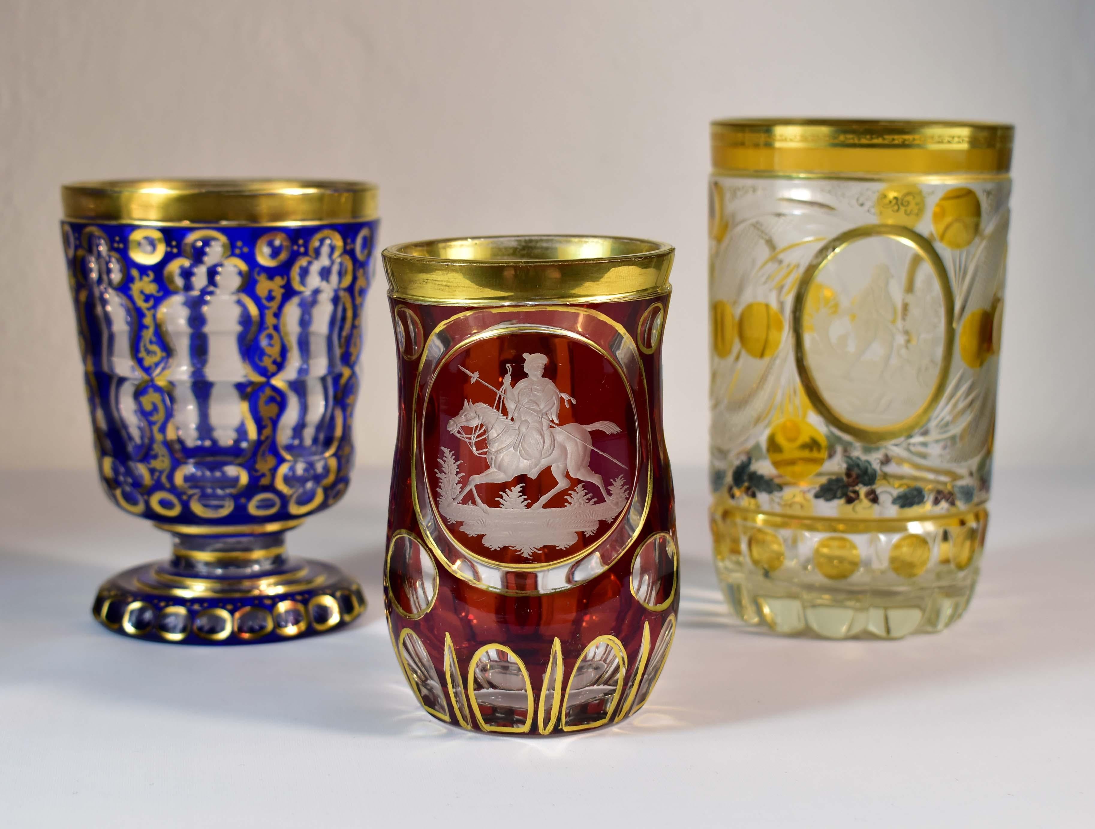 Satz von drei schönen Vintage-Pokalen. Der erste Pokal ist klar mit blauem Kobaltglas überfangen, wunderschön geschliffen im typischen Stil des 19. Alles ist mit ornamentaler Malerei und auch mit Vergoldung versehen. Auf der Unterseite befindet sich