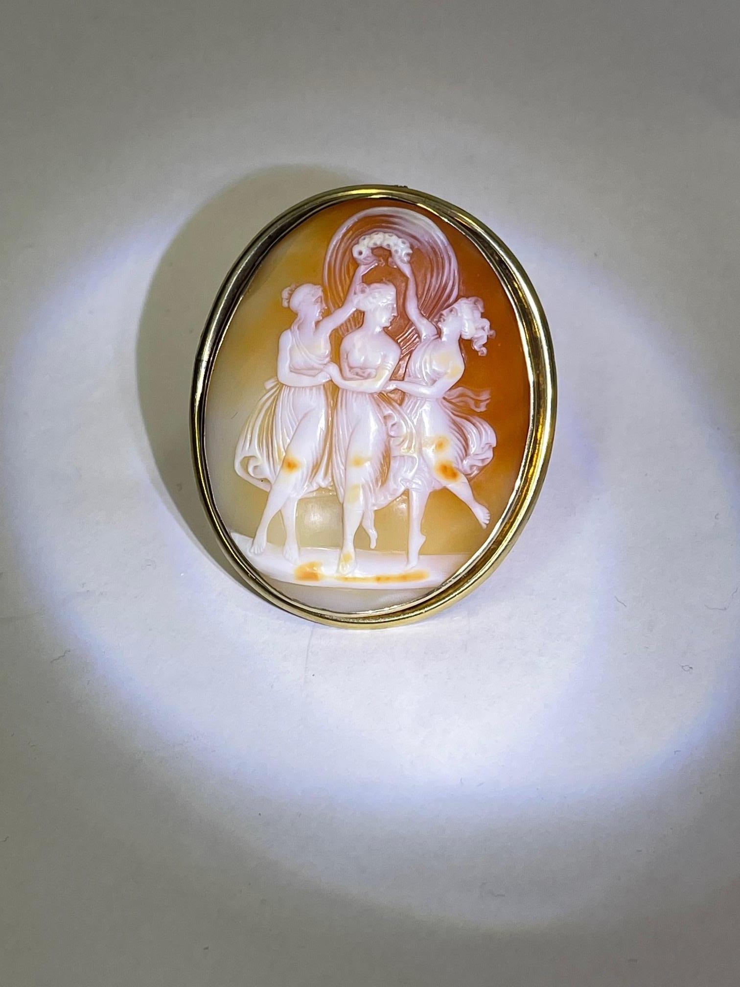 Simply Beautiful! Elegant and Stylish Antique Cameo Brooch Pendant depicting The Three Graces; Beautifully Hand Carved in High Relief Estate piece; Meticulously artisan engraved with exquisite detail, this romantic natural carnelian shell cameo is