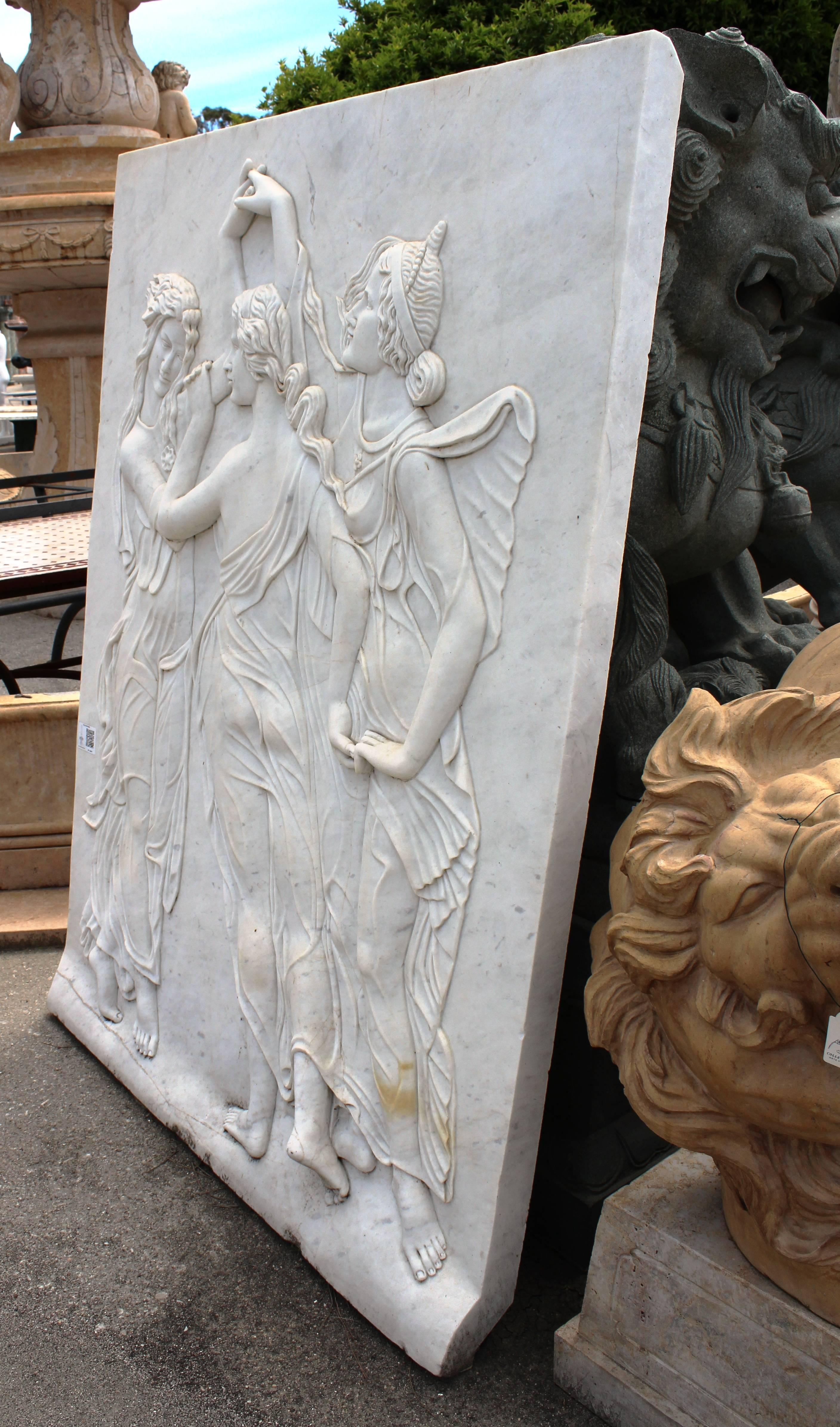 Hand-carved white Carrara marble relief of Botticelli's three Graces, a group of three females that join hands in a dance, representing the antique virtues of women: charm, beauty, nature, human creativity and fertility.
   