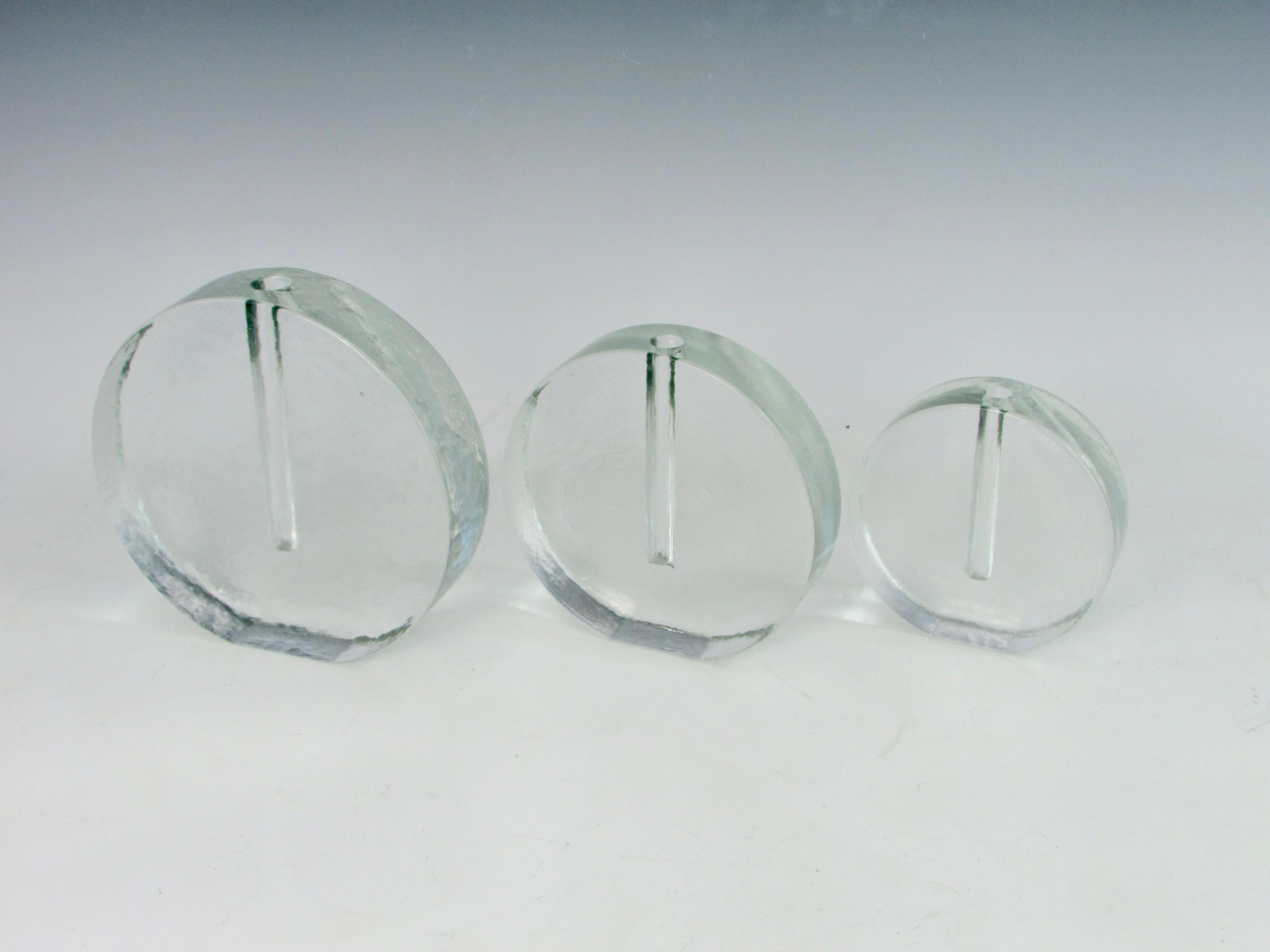Set of three graduated height circular glass bud vases. Solid cast glass in frosty Ice texture. Attributed to Tapio Wirkkala for Littala of Finland. Measures: Smallest 5