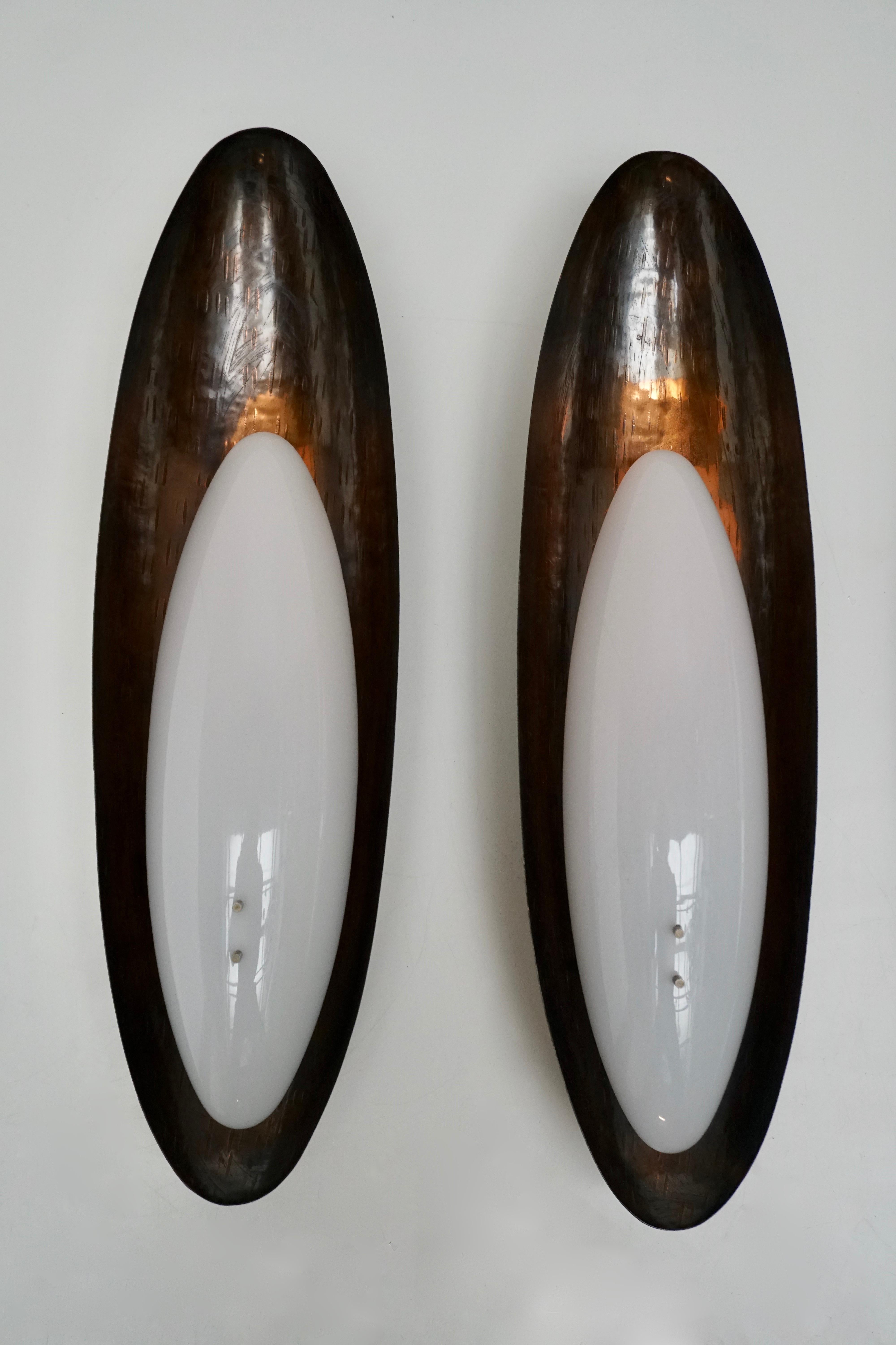 One  sconce by Reggiani. Designed and manufactured in Italy, circa 1960s. Hand-hammered copper and Perspex.
Takes two E27 25w maximum bulbs.

Two pieces are sold.