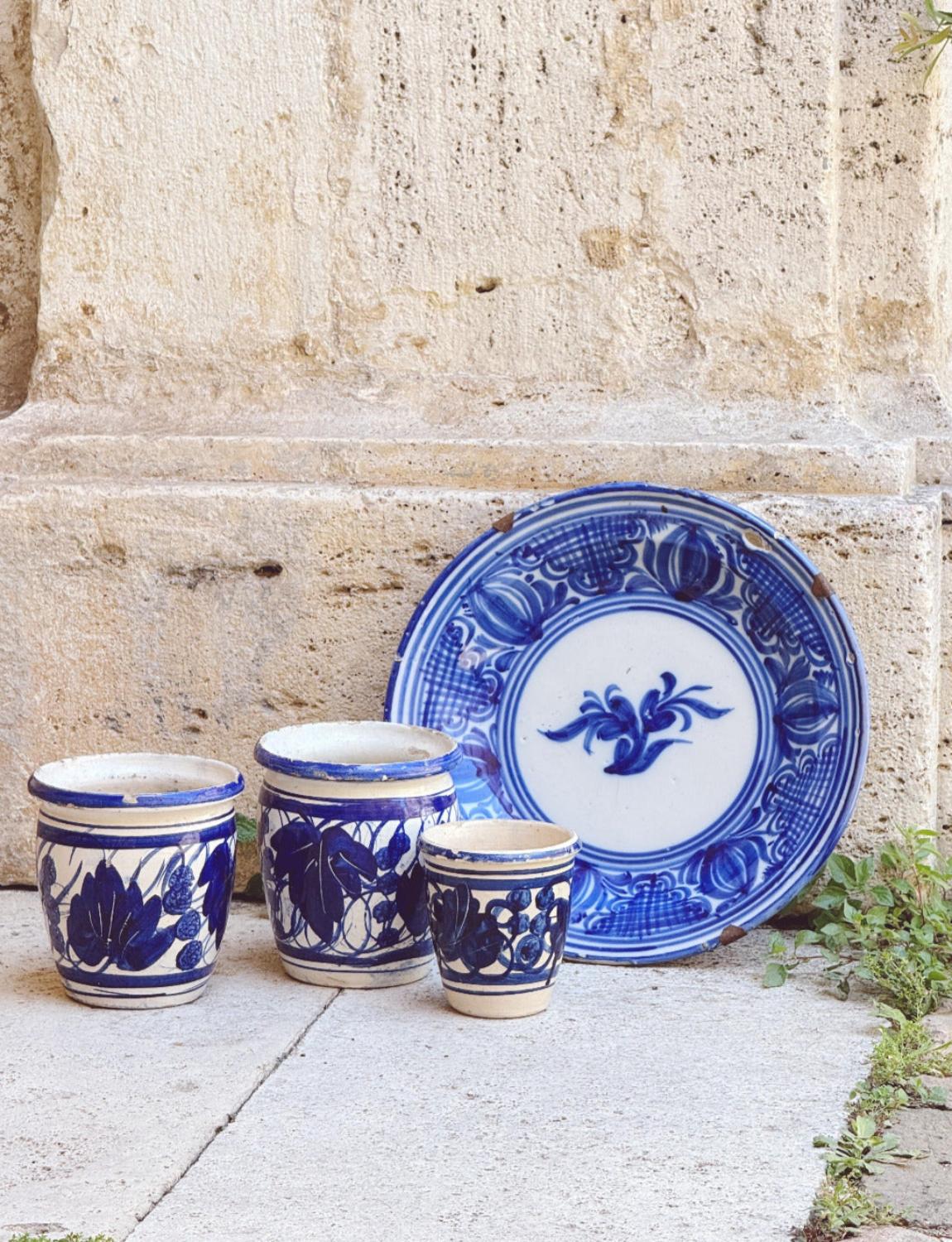 Maravilloso conjunto de macetas de cerámica de Apulia pintadas y hechas a mano y un plato de flores siciliano. Las cuatro piezas están pintadas a mano con motivos florales y de hojas de color azul intenso y son absolutamente encantadoras. El soporte