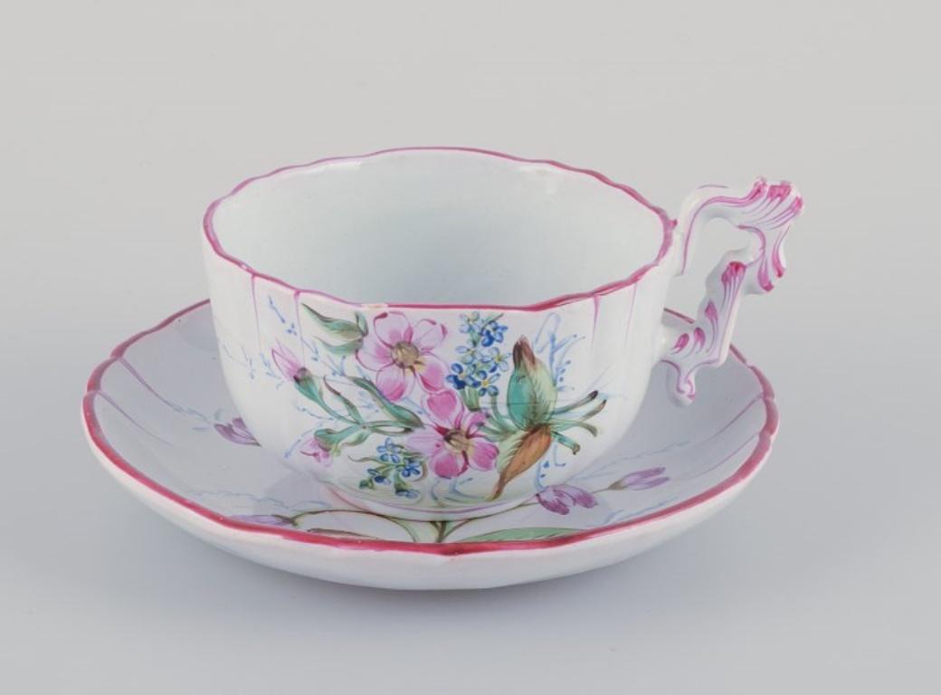 Three hand-painted tea cups and saucers in faience with motifs of flowers and insects. 
Style of Emile Gallé.
1870s.
Marked.
In excellent condition with natural cracks. One cup has a microscopic chip on the top edge. See photo.
Cup: H 5.5 cm x D 9.0