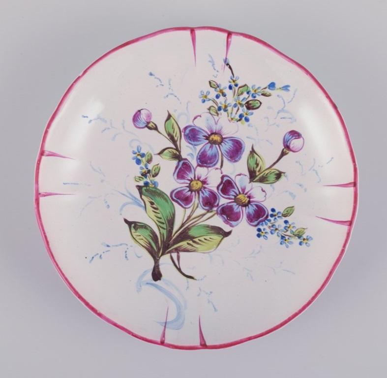 Faience Three hand-painted tea cups and saucers in faience with motifs of flowers. For Sale