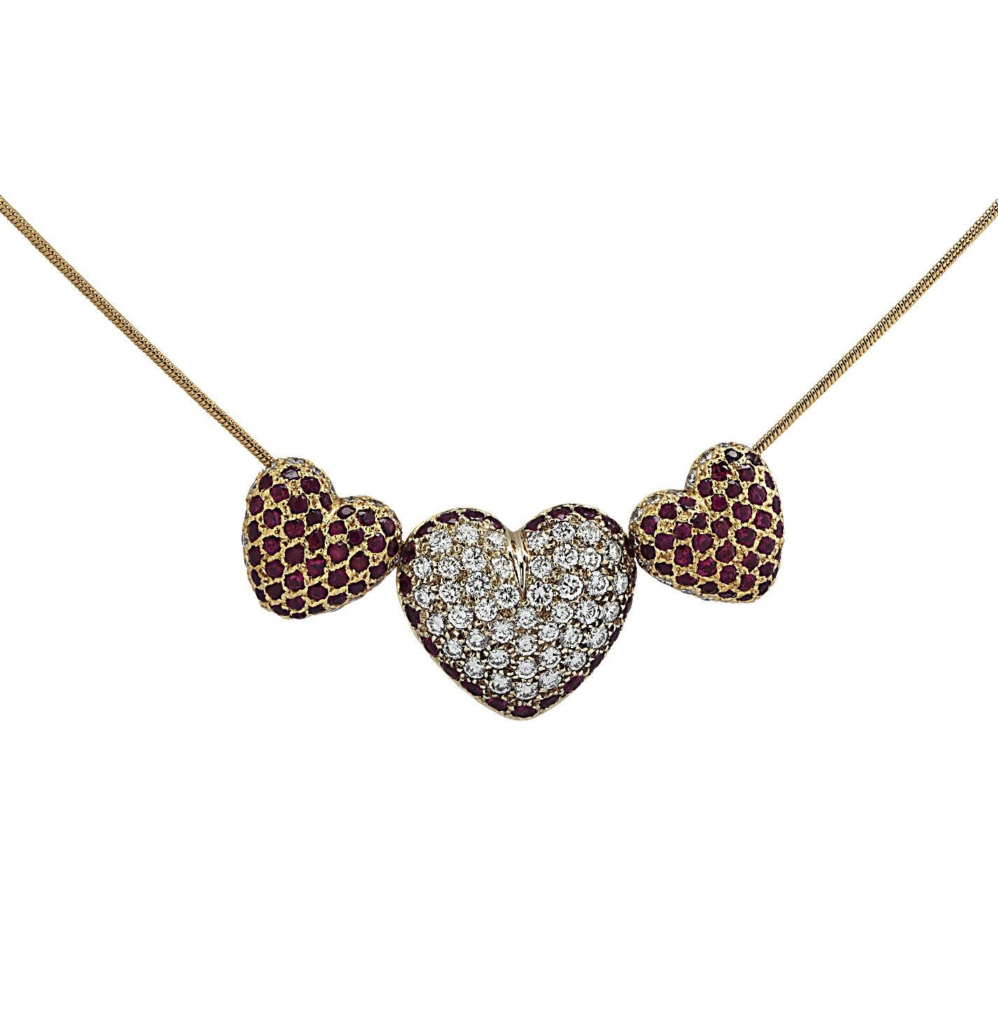Love is in the air with this delightful necklace, crafted in 18 karat yellow gold, featuring 88 round brilliant cut diamonds weighing approximately 2.3 carats total, F-G color, VS2-SI1 clarity, and 97 rubies weighing approximately 3 carats total. A