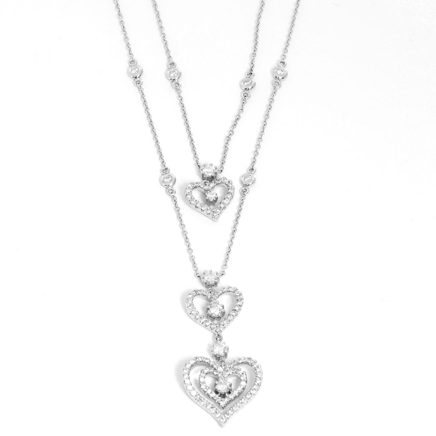 Three Hearts Diamond Necklace  - Chic and unique necklace with two diamond by the yard chains with heart pendants. Featuring 120 Round brilliant cut diamonds set in White Gold. Approximately weighing 4 cts. Diamond clarity VS-2 to SI-1. Diamond