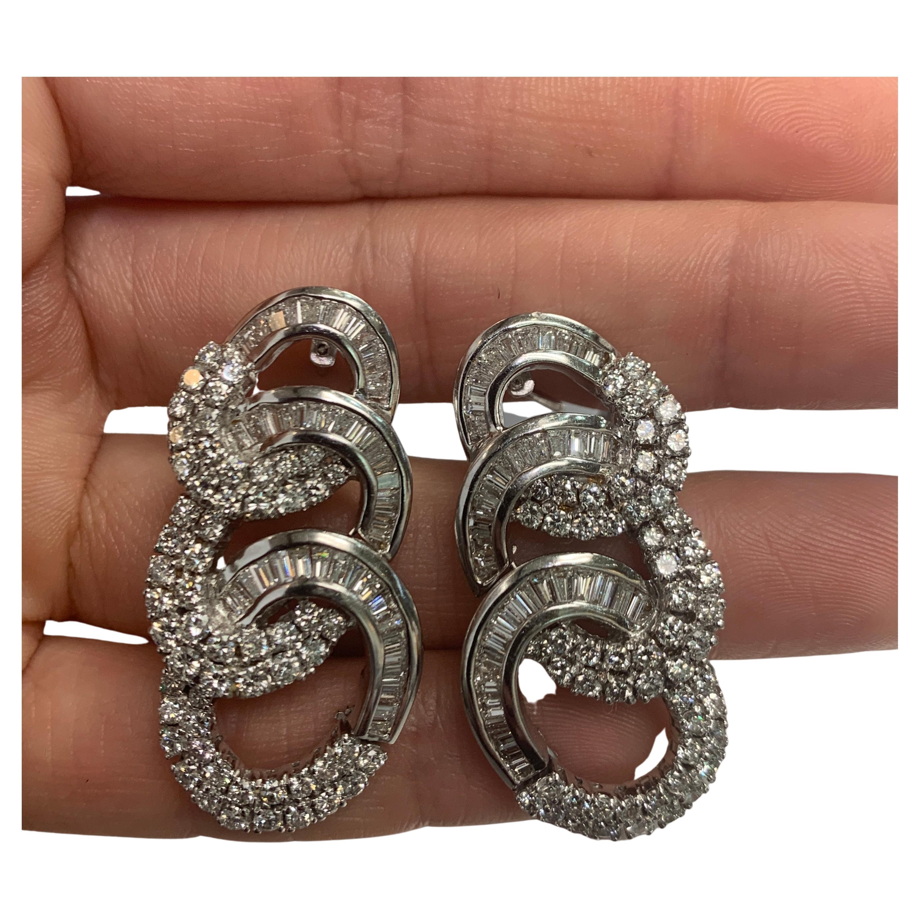 Three Hoop Diamond Earrings

Diamond Weight: approximately 7.00 cts 

Three graduated attached hoops consisting of round & baguette cut diamonds set in 18k white gold 

Back Type: clip on with post 

Measurements: 1.25