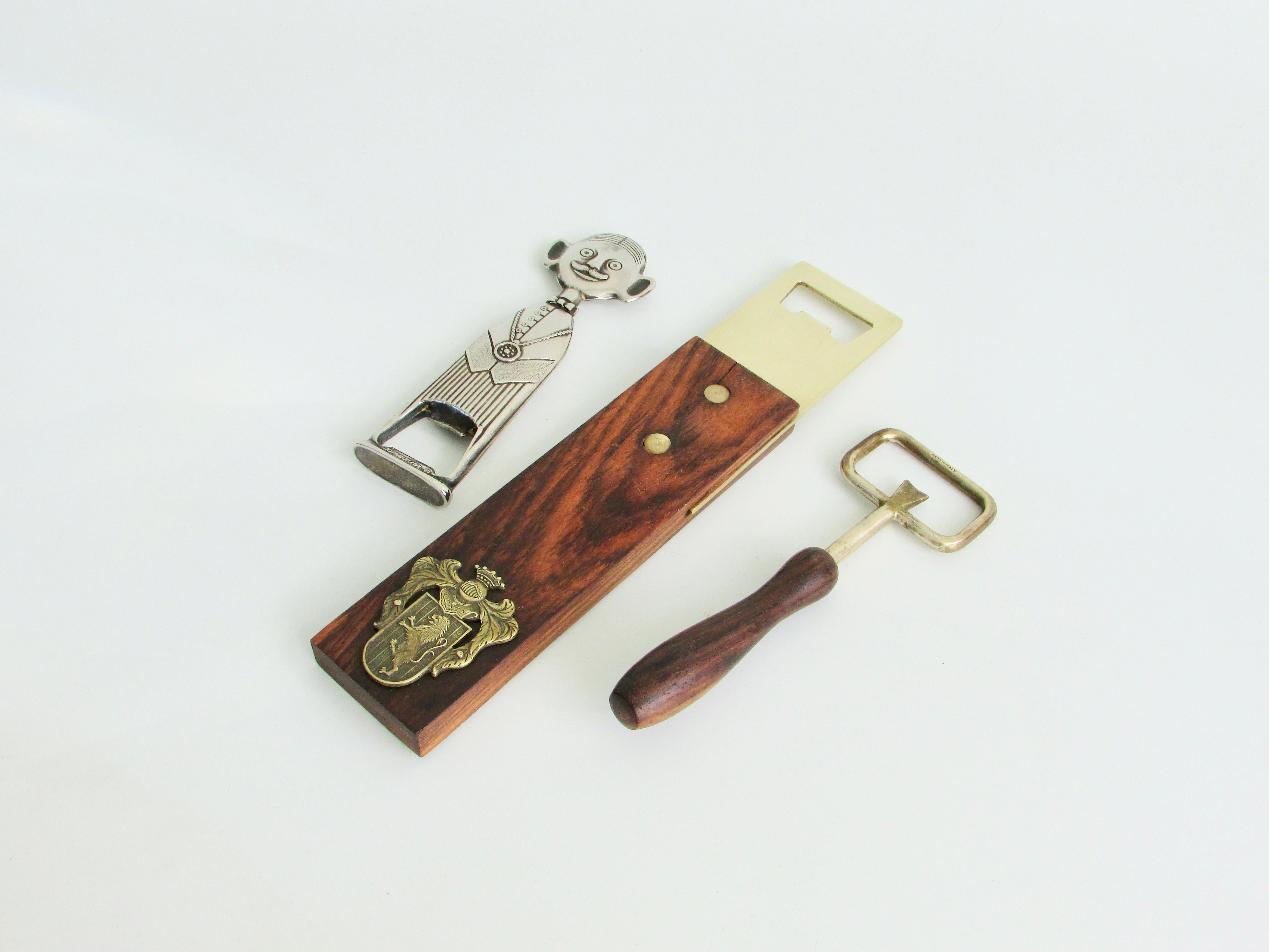 Three separate bottle openers in clever modernist designs . Each marked and made in Italy .Round handle piece measures 7x2.25 . Chrome figural opener measures 6.25 x 1.75 also signed Sommelier . Large rectangular rosewood with brass head measures