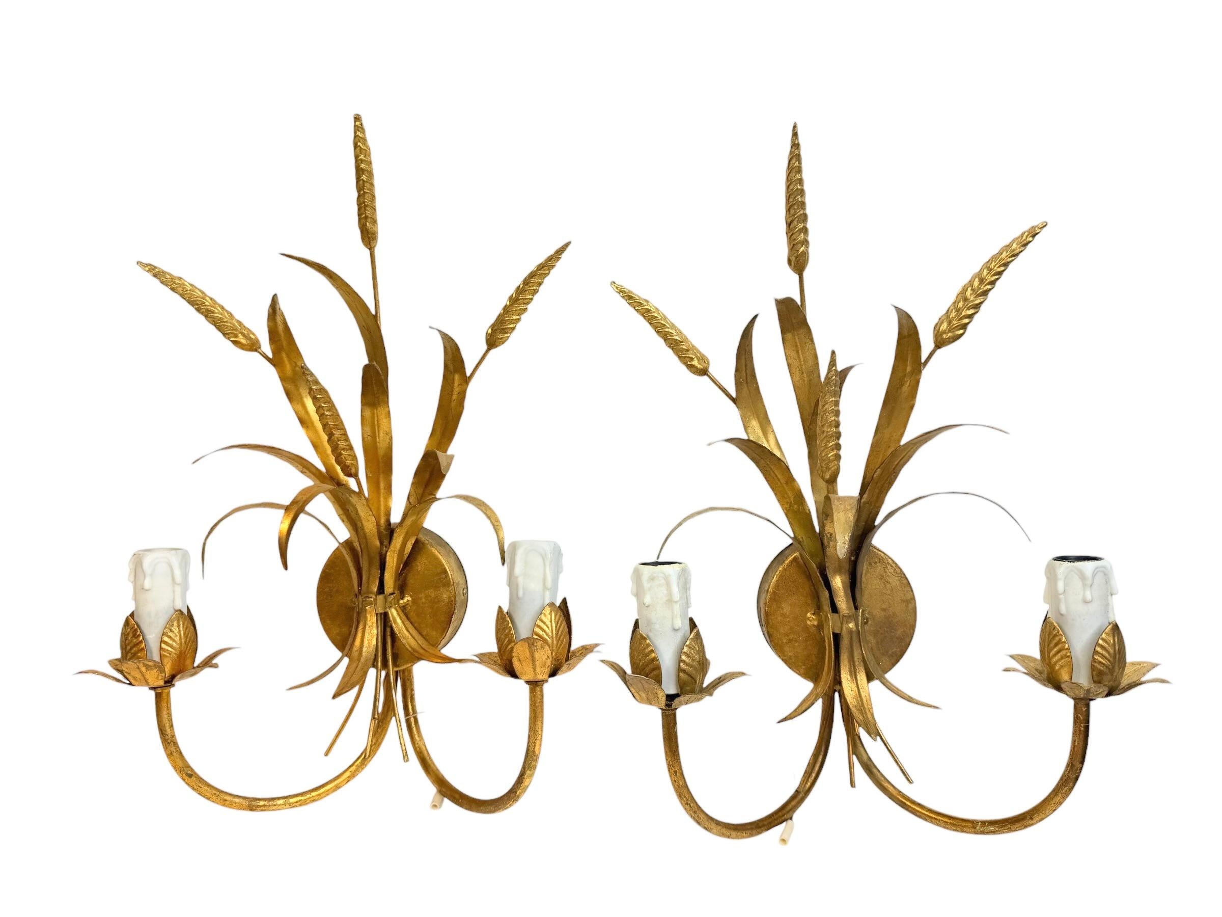 A set of three Hollywood Regency midcentury gilt tole wheat sheaf sconces, each fixture requires two European E14 candelabra bulbs, each bulb up to 40 watts. The wall lights have a beautiful patina and gives each room an eclectic statement. Found at