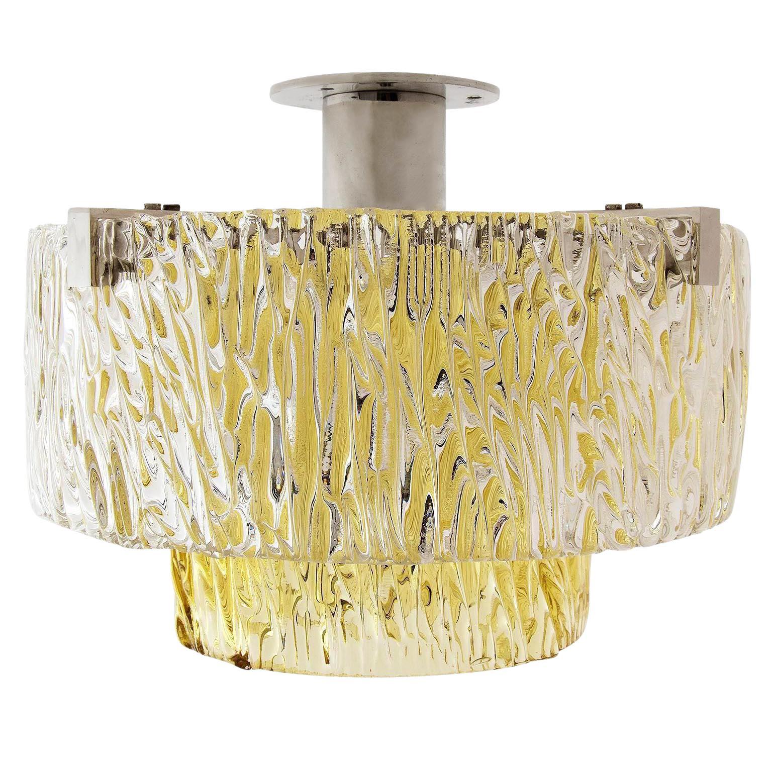 One of two fantastic textured glass and nickel-plated brass flushmount light fixtures by J.T. Kalmar, Austria, manufactured in midcentury, circa 1960. 
The outer tier is made of two clear glass half rings. The inner ring is made of one piece of