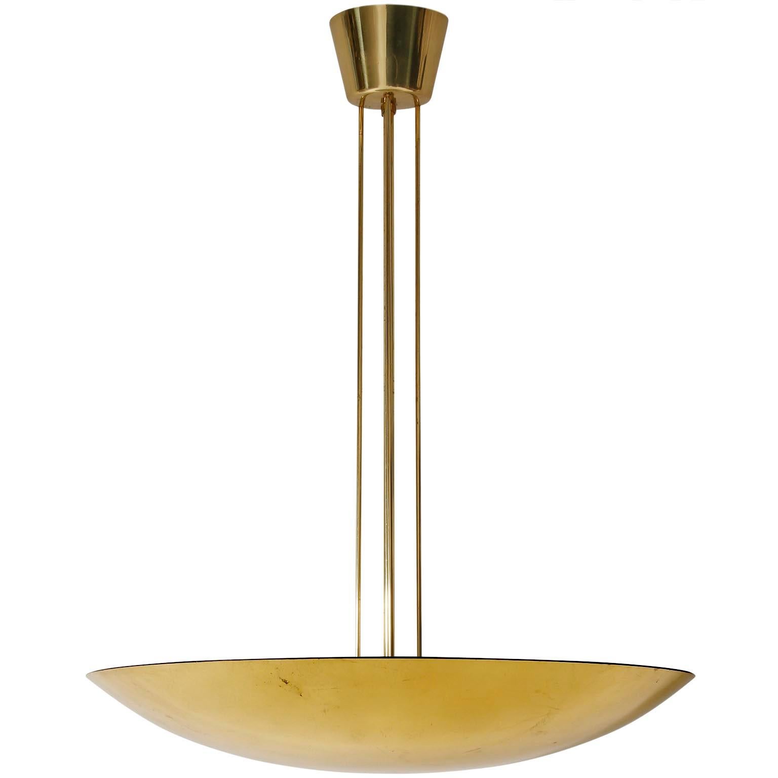 One of three polished brass bowl up light chandeliers / pendant light fixtures by J.T. Kalmar, Austria, manufactured in midcentury, circa 1970 (late 1960s or early 1970s).
This uplighter has three sockets for medium screw base bulbs. It works well