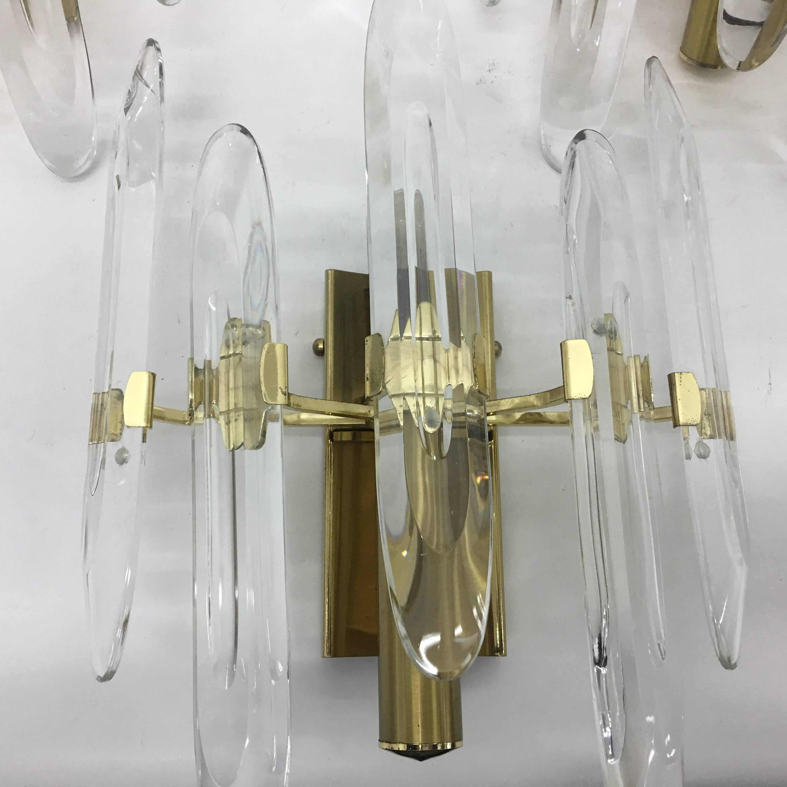 Amazing set of three brass and optical glass wall sconces in perfect conditions. compatible with 110 v. Designed by Gaetano Sciolari per Stilkronen
