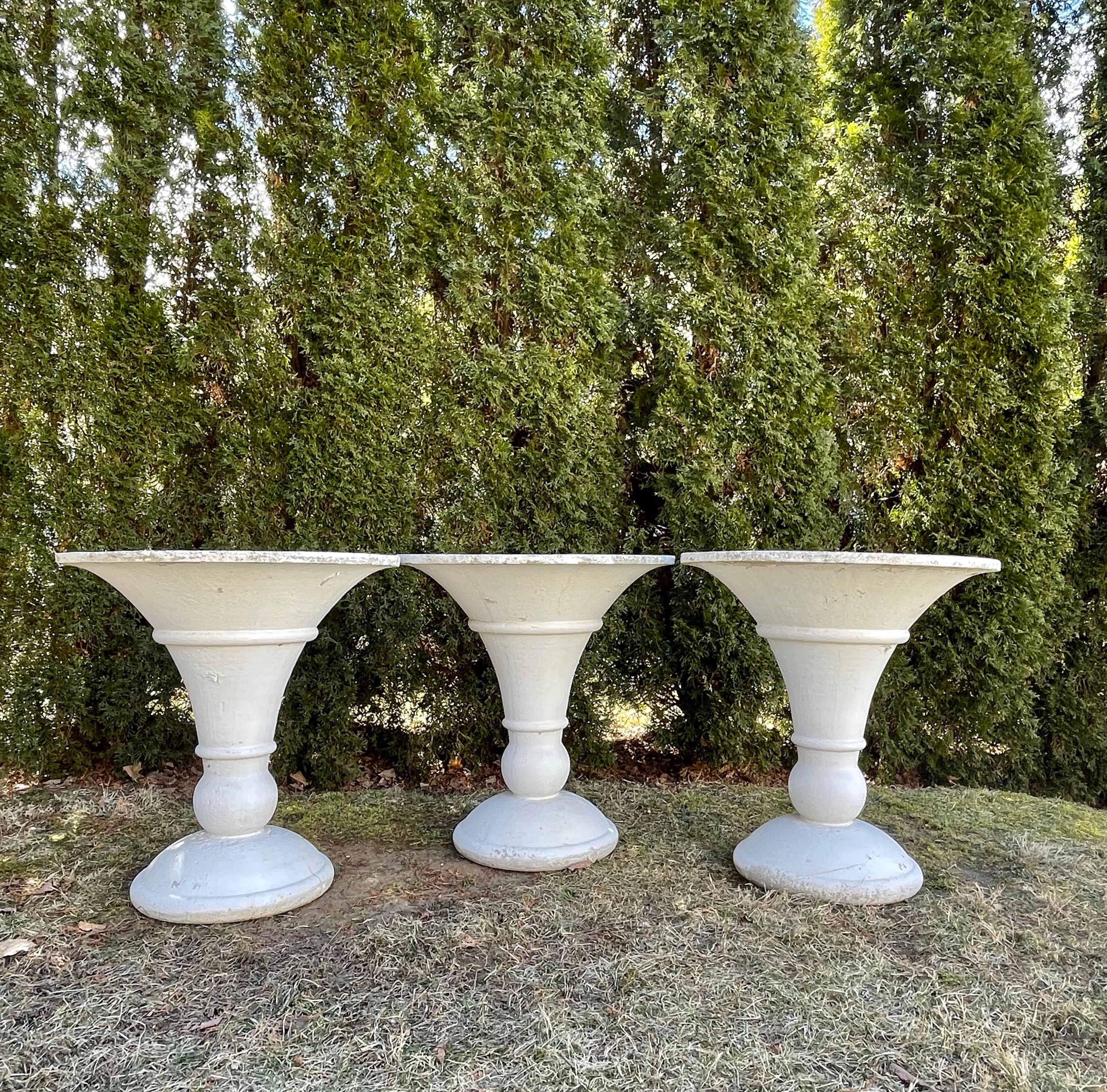 The form of these heavy cast stone planters is so elegant and the planting wells so capacious that you will find so many places to use these in your garden. Art Deco in style, they go with everything and will give you decades of pleasure. We