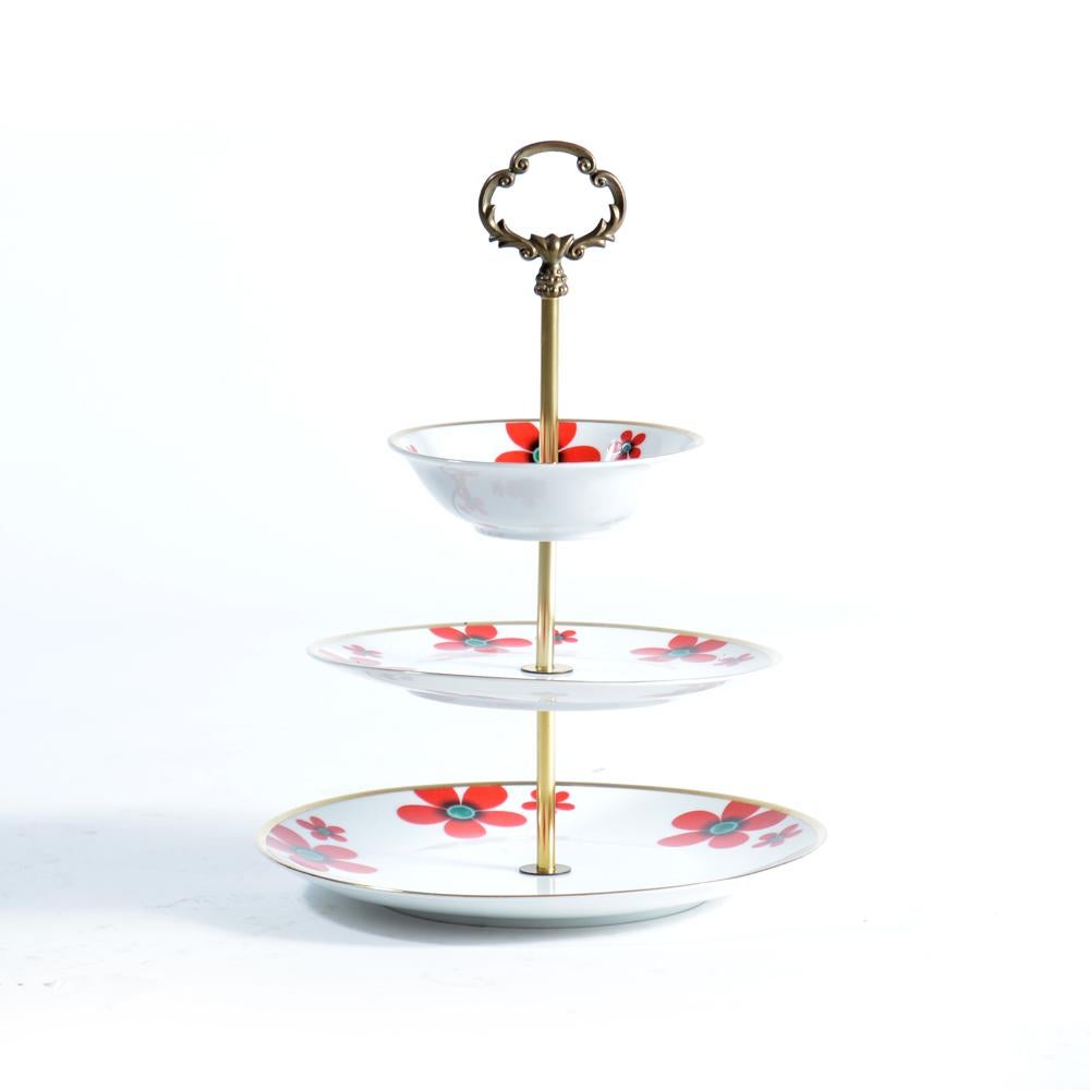 Beautiful item with lots of style. Typical cake stand designed with three layers of porcelain plates. Plates are made of white porcelaine with colorful ornaments. The stands is in an excellent condition. The beautiful flowers and hand-painted gold
