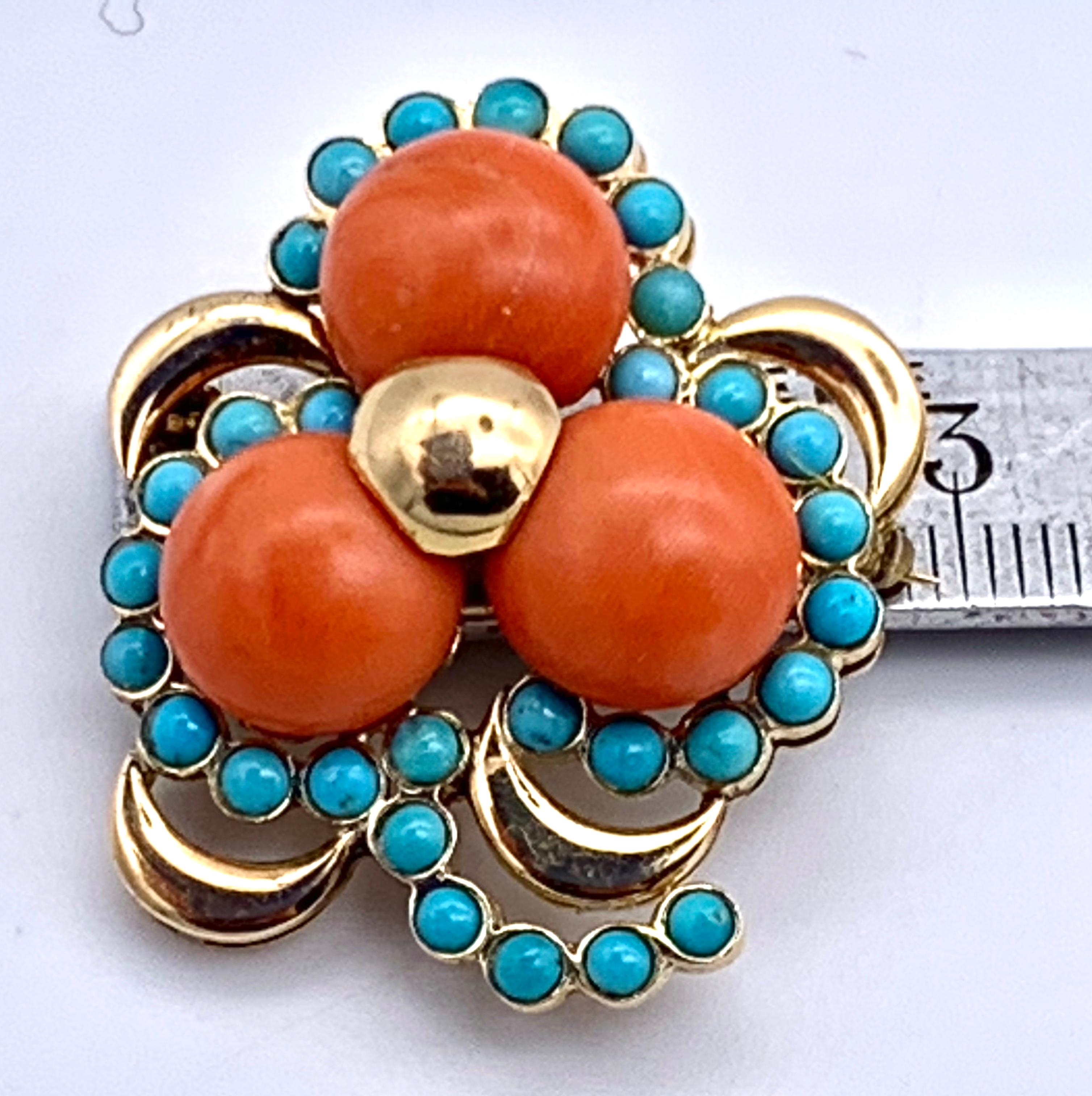 Wonderful chunky brooch in the shape of a three leaf clover made out of 14k gold, button coral and turquoise.