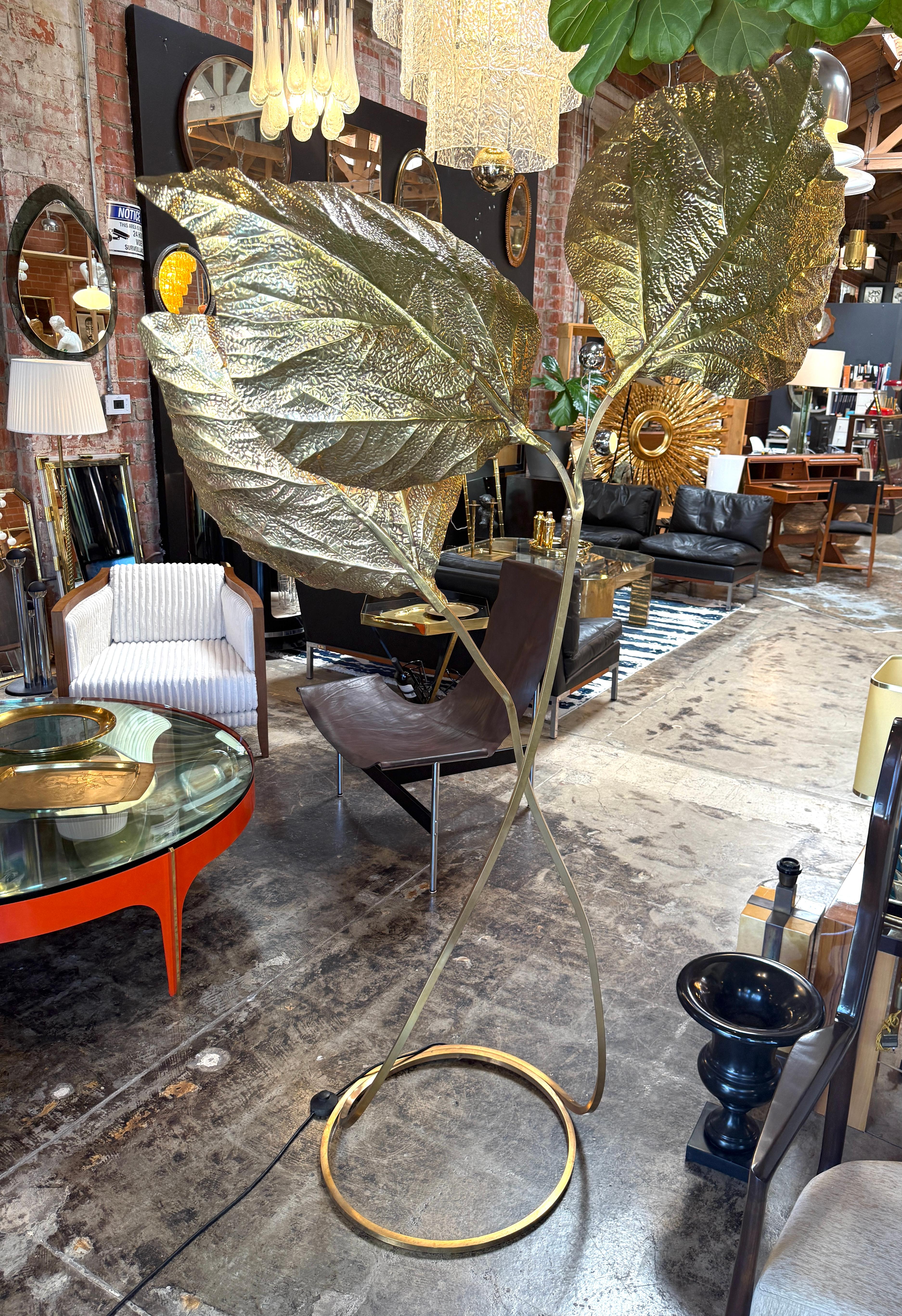 This floor lamp by Tommaso Barbi, designed in the 1970s, is a captivating expression of his signature organic style. Composed entirely of hand-worked brass, the lamp features three large sculptural leaves, each meticulously textured with