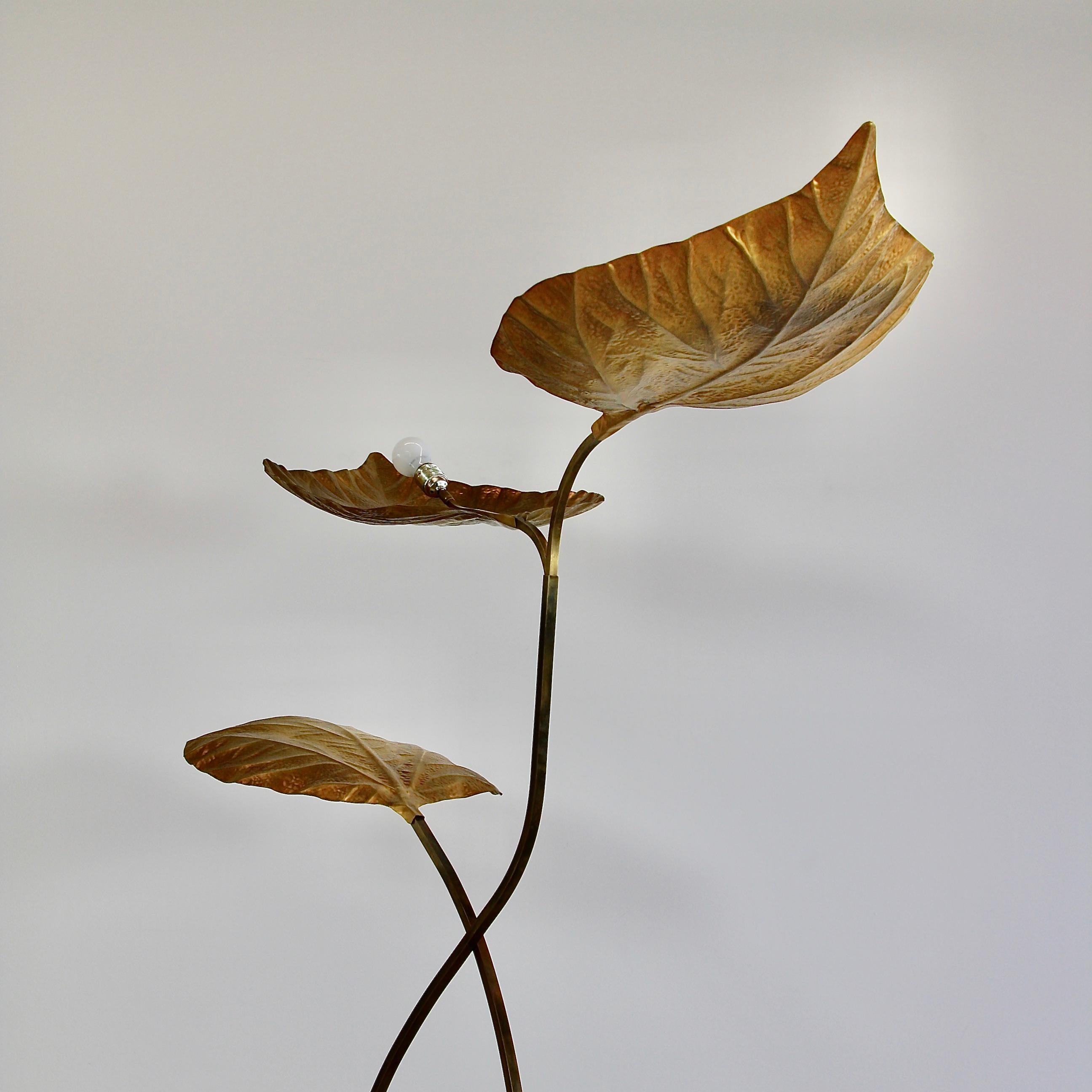 Floor lamp designed by Tommaso Barbi in the 1970s for Bottega Gadda, Italy.

Brass lamp with the three-light fittings. Three-leaf model of the 'Rababarbo' or rhubarb leaf floor lamp with embossed leaves. Handmade using repousse and chasing