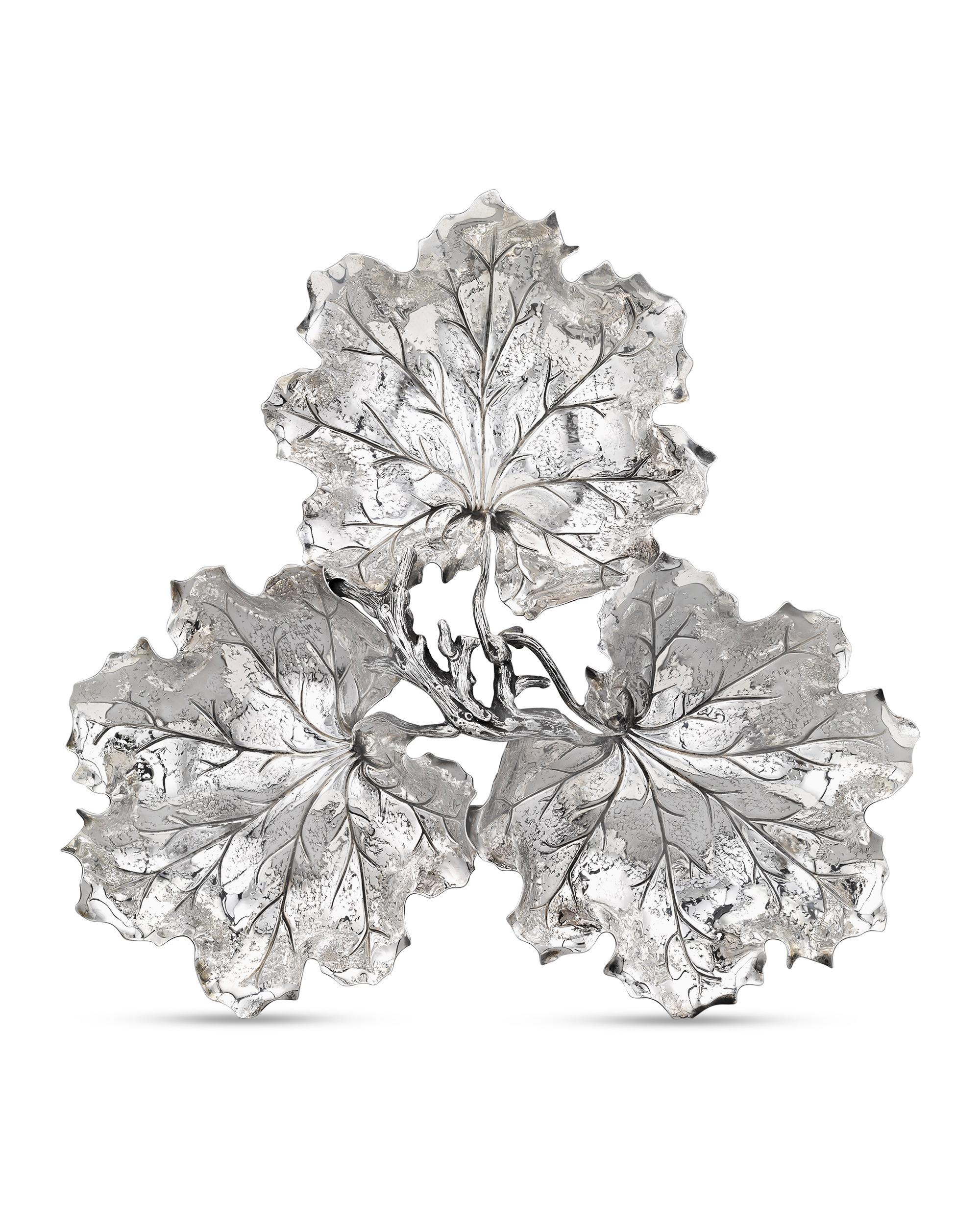 Three geranium leaves are masterfully re-created in sterling silver by the Italian firm Buccellati to form this serving tray. Buccellati is world-renowned for their work in silver and gold, creating highly textural pieces such as this with an