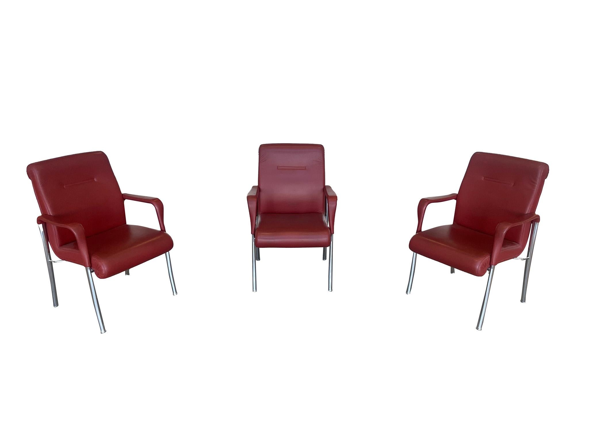 Three fabulous dining or office chairs by iconic Italian chair maker Poltrona Frau. Characterized by the quality of leather, craftsmanship, and open spiral edges that is common throughout Poltrona Frau pieces. Crafted in Oxblood Red leather with