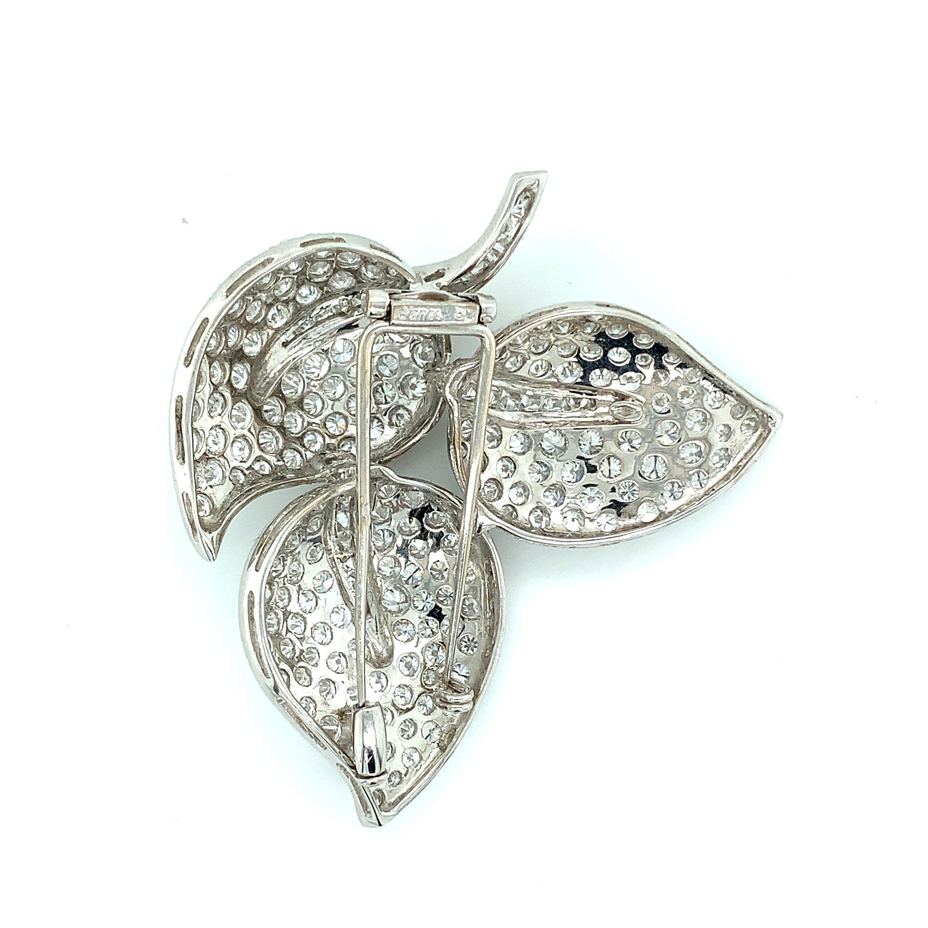 A stunning brooch featuring very nice, beautiful clean diamonds set in 18 karat white gold. It comes in a creative three leaves design. The diamonds weigh approximately 12 carats, which is certain to catch everyone's attention. 

Total weight: 20.5