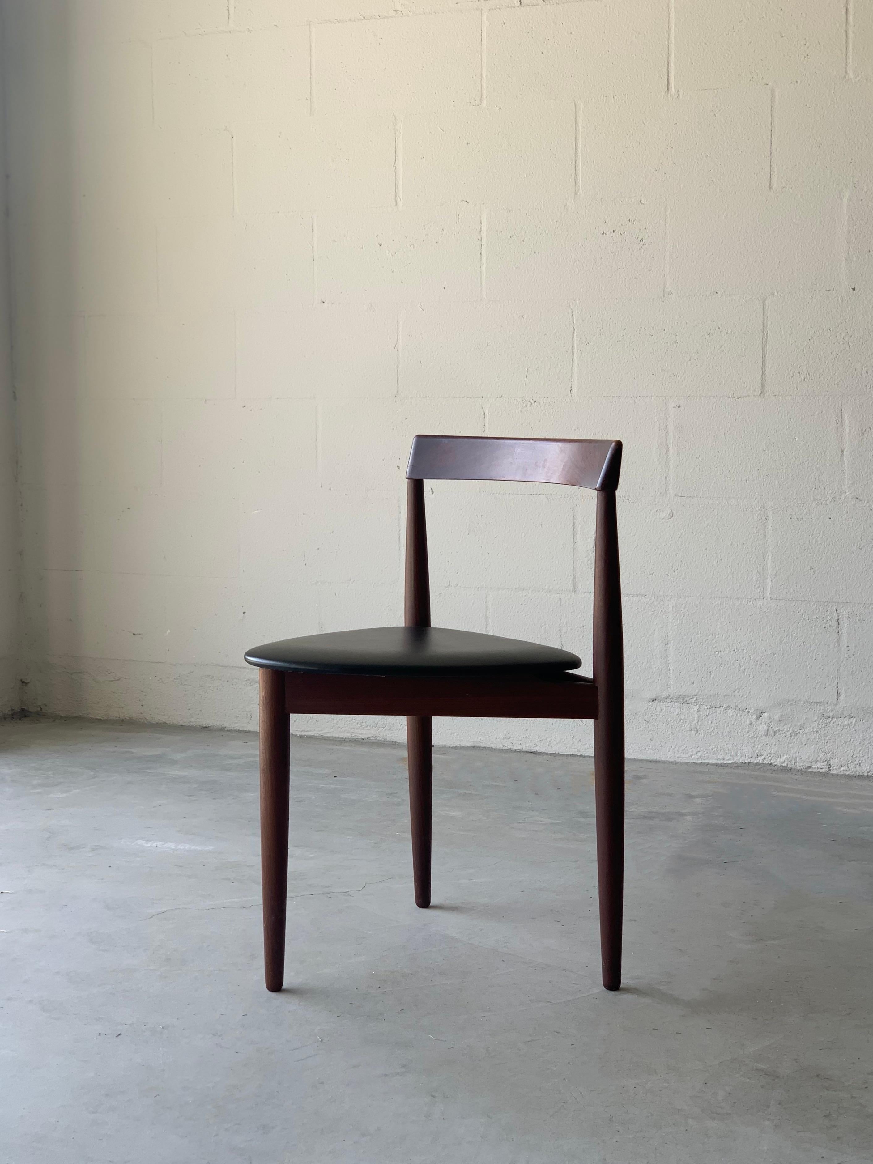 Artful three legged chair / stool in rich walnut finish and black upholstered vinyl. A wonderful example of form and function, stool is able to sustain an ample amount of weight , perfect as extra seating , compact enough to use in varied communal