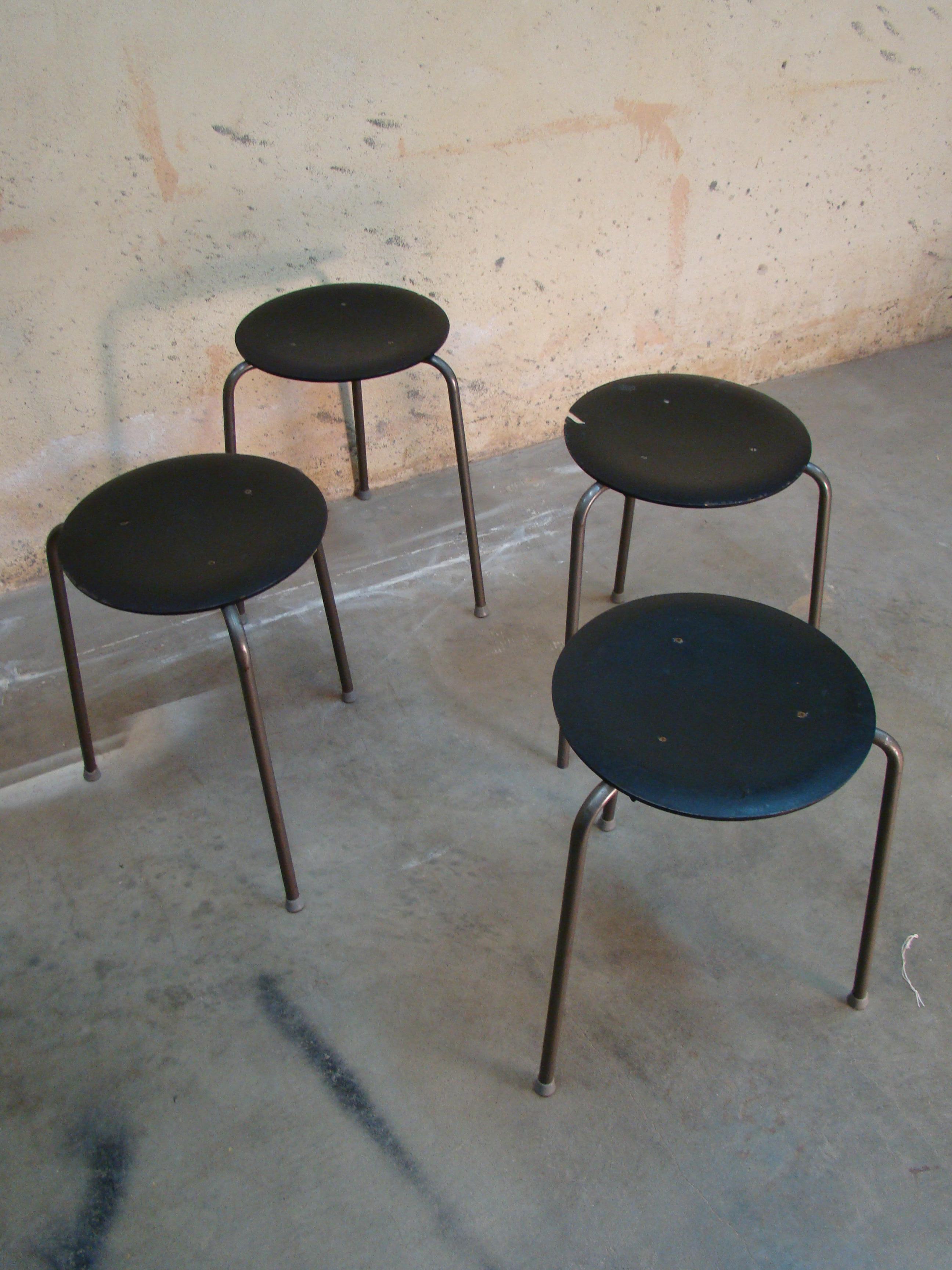 This vintage three-legged stacking stool, made in Denmark circa 1960s is styled in the manner of the iconic stacking stool by Arne Jacobsen for Fritz Hansen. 

These were mass produced to a lower build quality than originals substituting painted