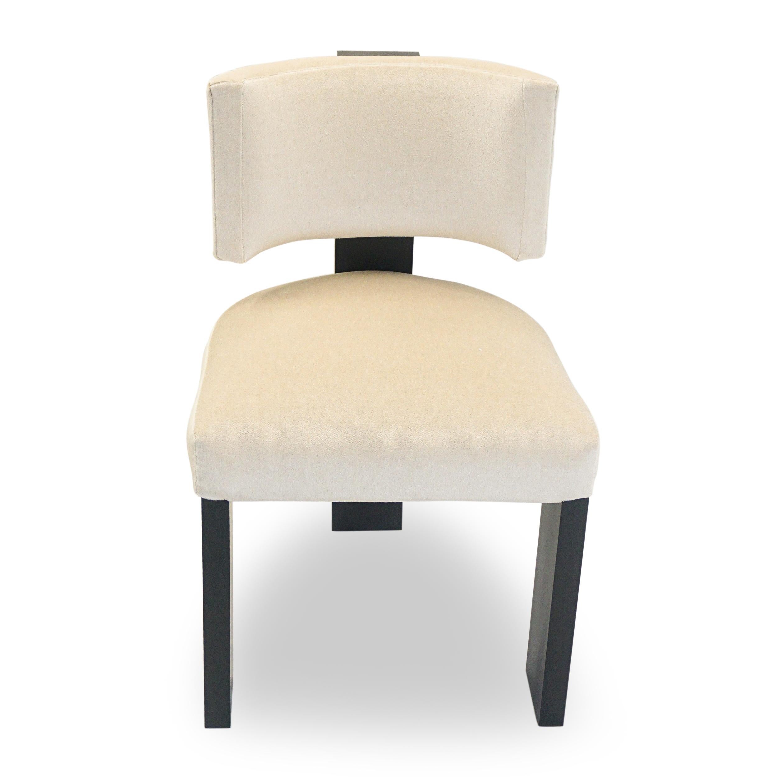 Modern three legged dining chair with blackened hard maple legs. The curved back cups just beneath most shoulder blades and the chair encourages good posture. The back can be pitched if desired for a more relaxed sit. The chair is shown in beige