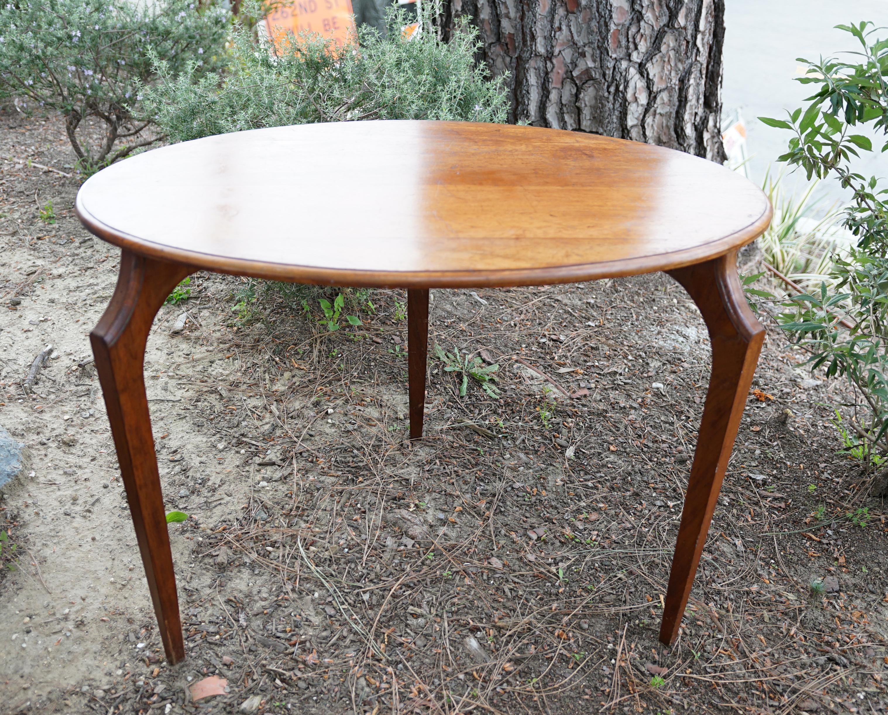 The shape, the style, the age and patina are just a few of the elements that make this table fantastic. It is a three-legged oval walnut table. This could have been a writing table originally for one person to pull up a chair and spread out pens and