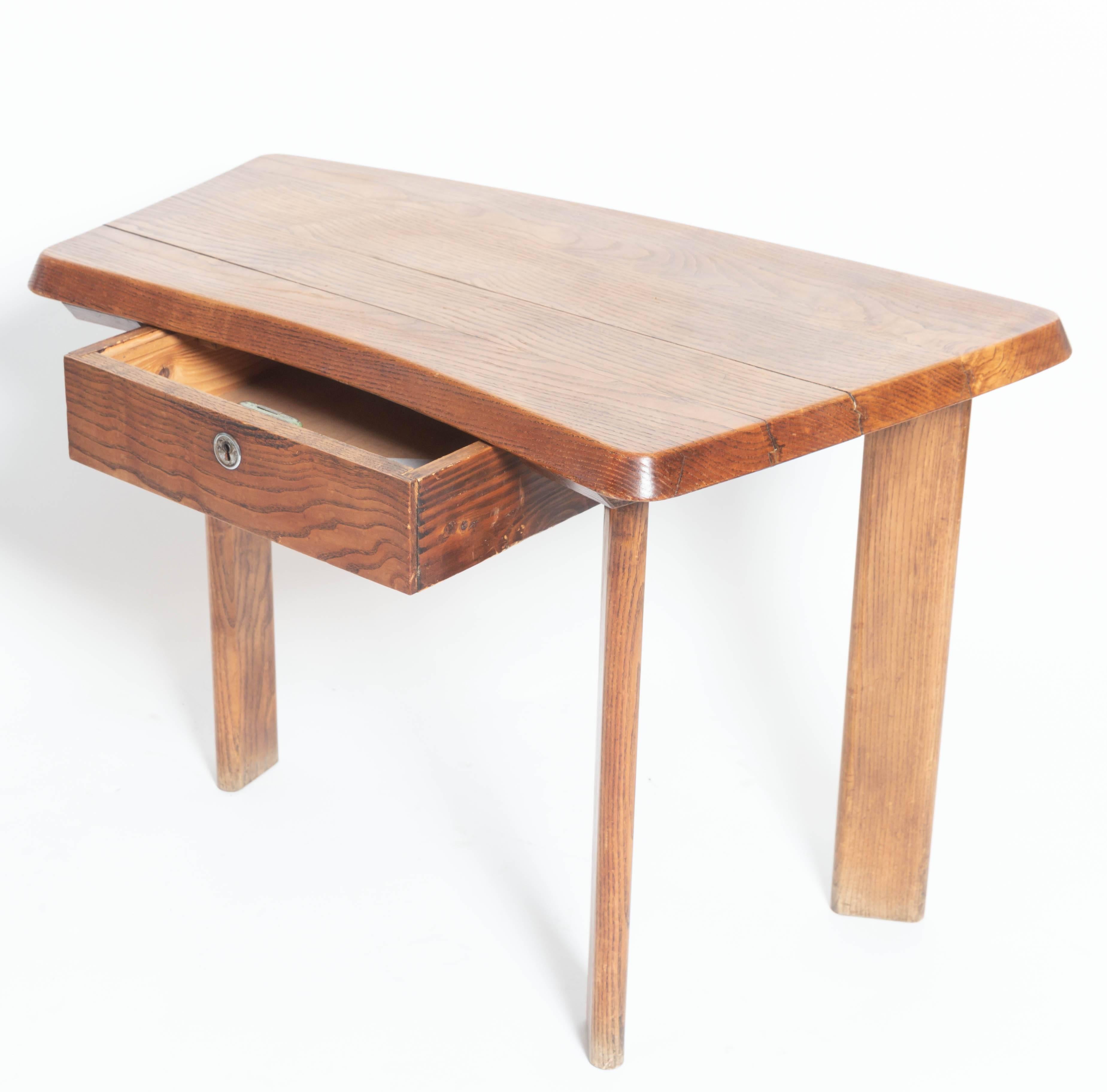 Wooden oak table with drawer and three legs, in the manner of Charlotte Perriand.