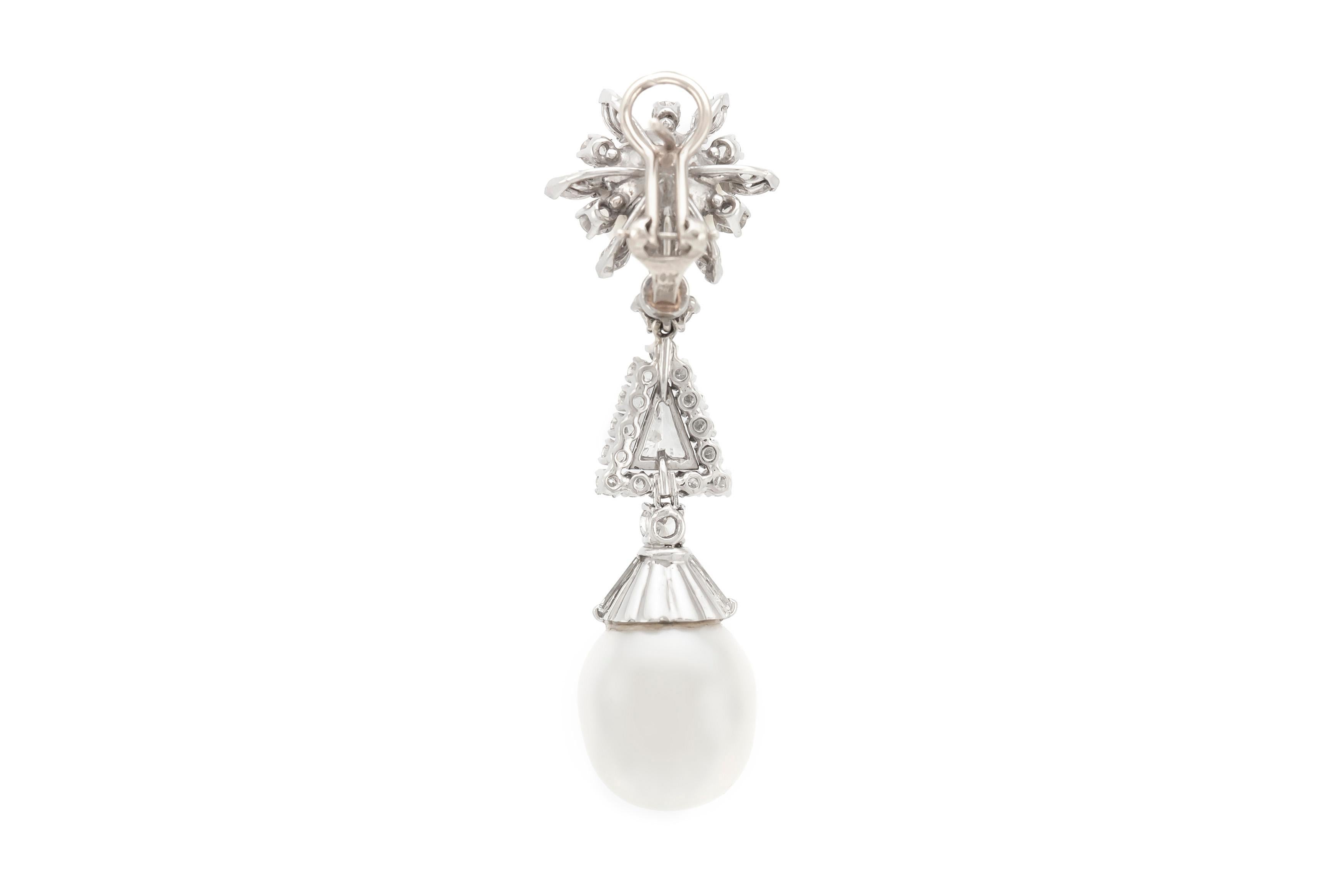 The earrings are finely crafted in platinum with four pearls two on top and two on the low level of the drop. With diamonds weighing approximately total of 3.00 carat.