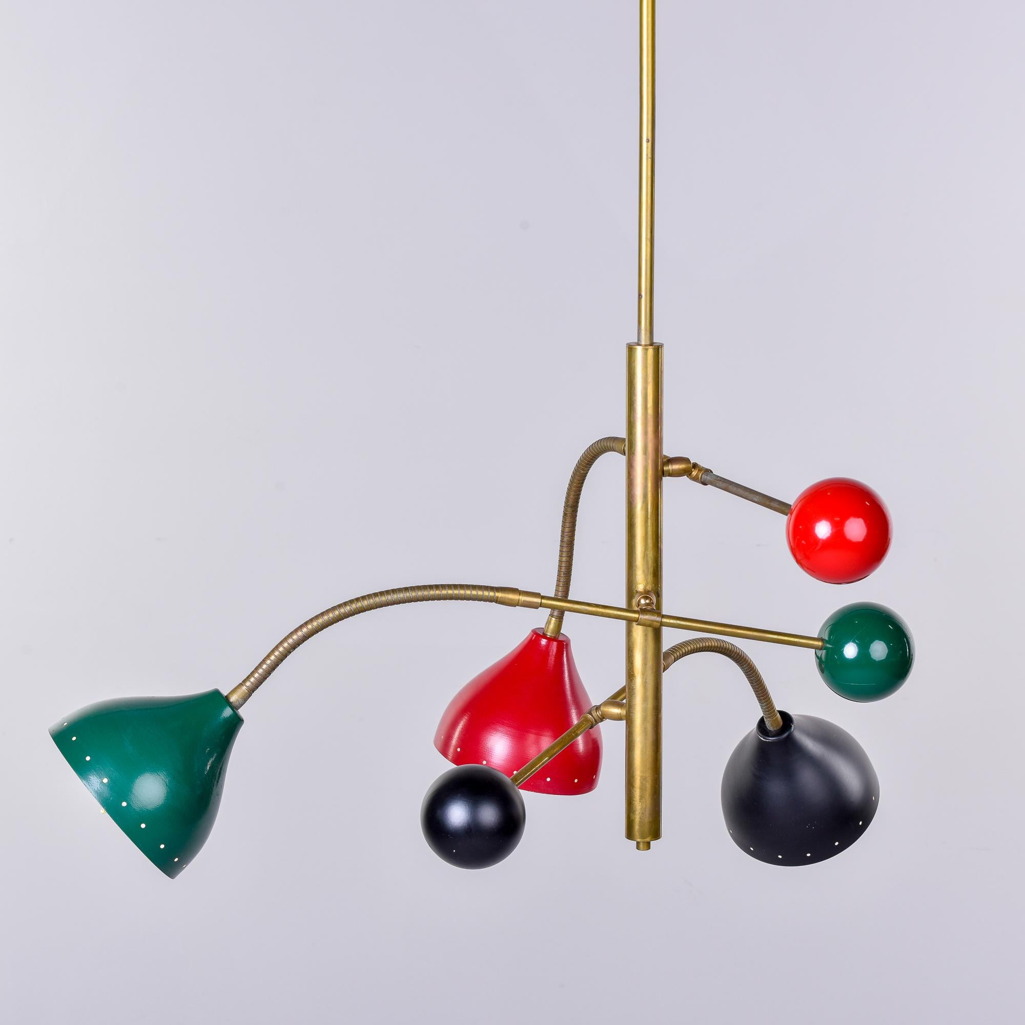Found in Italy, this three light multicolor fixture is attributed to Stilnovo. The hanging pendant has three light arms and each has a brass stem with a bendable section near the shade end along with a rigid brass section of arm near the sphere at