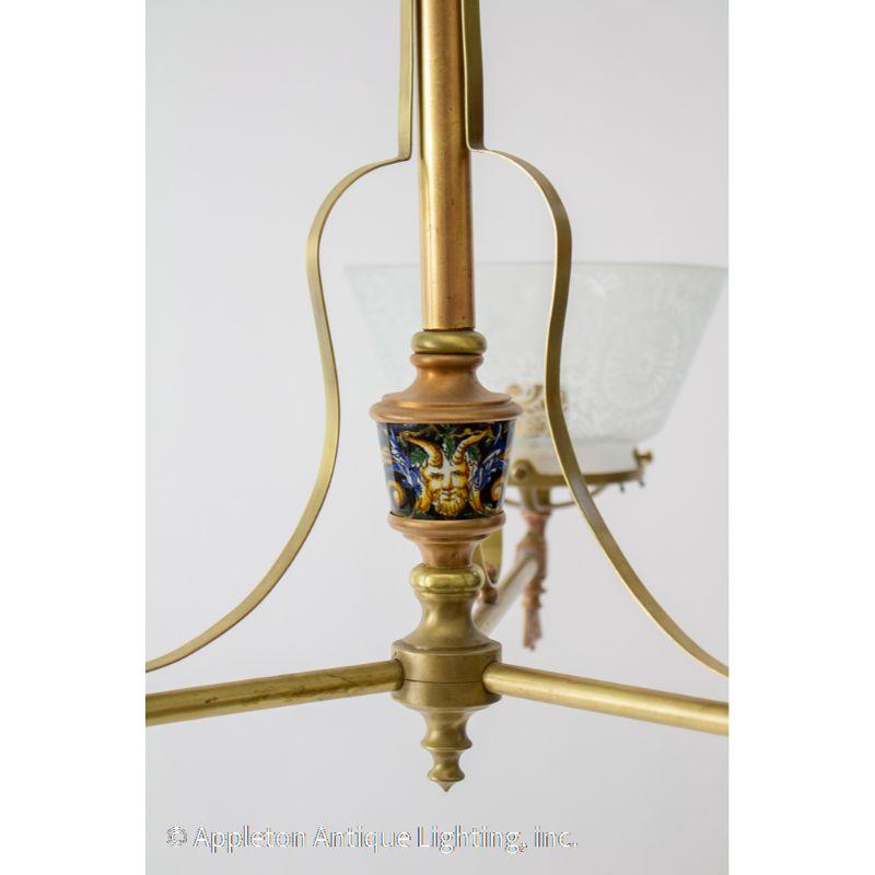 Late 19th century three light Satyr Aesthetic Movement gasolier. Porcelain break with a Satyr. Can be used with crystals or without. Simple tubular arms and curved decorative elements.

Material: brass, porcelain
Style: Victorian,