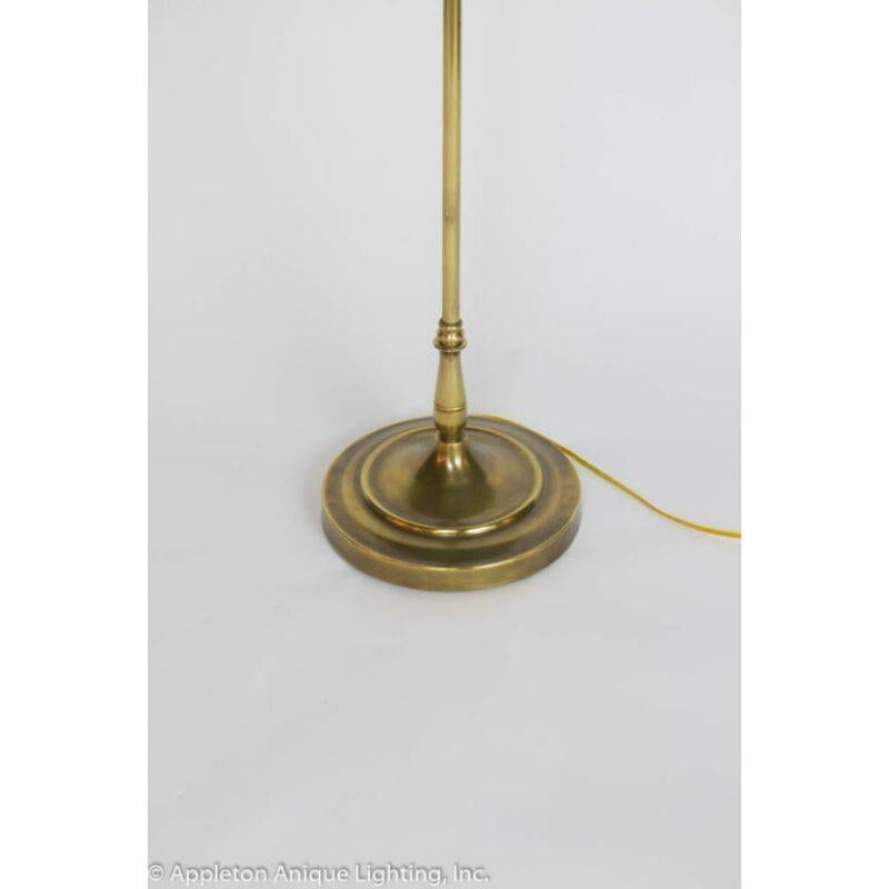 Three light classic floor lamp. Hand polished brass. New wiring and sockets. Includes red toile shade 18? Diameter.

Material: Brass
Style: Traditional,Transitional
Place of Origin: United States of America
Period made: Mid 20th