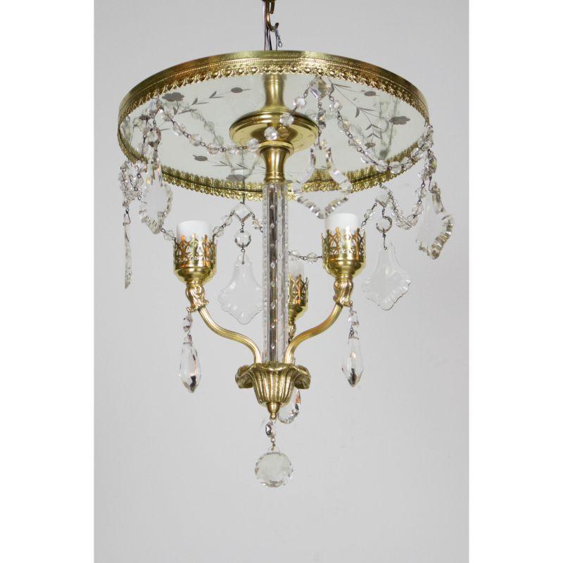 Three light flush brass and crystal chandelier. Mirrored ceiling plate, three lights. Completely restored, brass polished, all crystal cleaned and rehung. New wiring. Ready to hang. Perfect for a foyer or powder room. American, C.