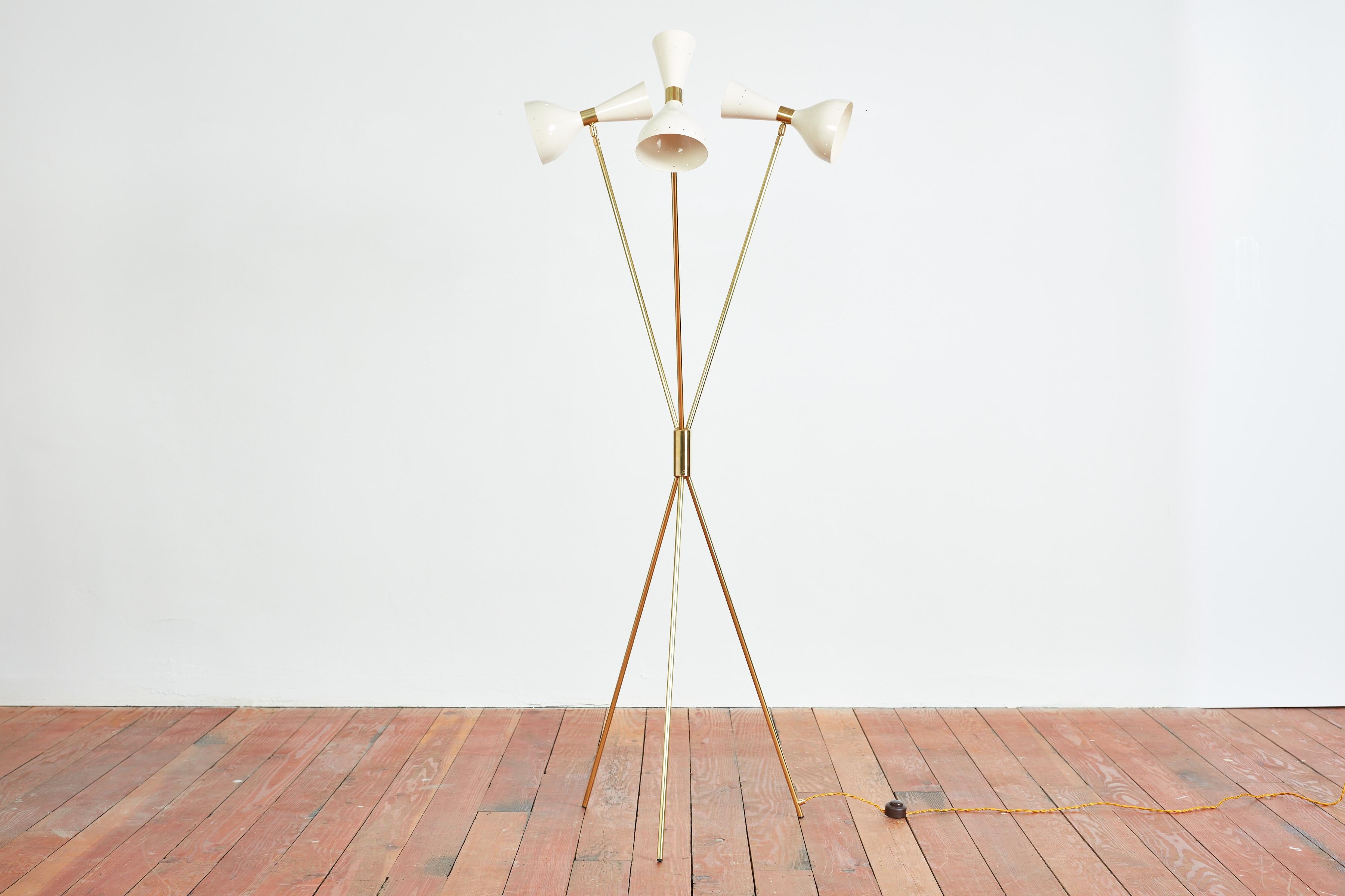 Fantastic tripod floor lamp attributed to Stilnovo with three articulating creamy white shades, brass arms and base. Newly rewired.