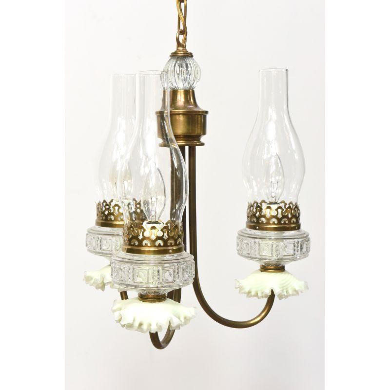 Three light oil style chandelier. Faux oil burners, with ruffled light yellow glass. Completely restored and rewired. American, C. 1940

Dimensions:
Height: 16