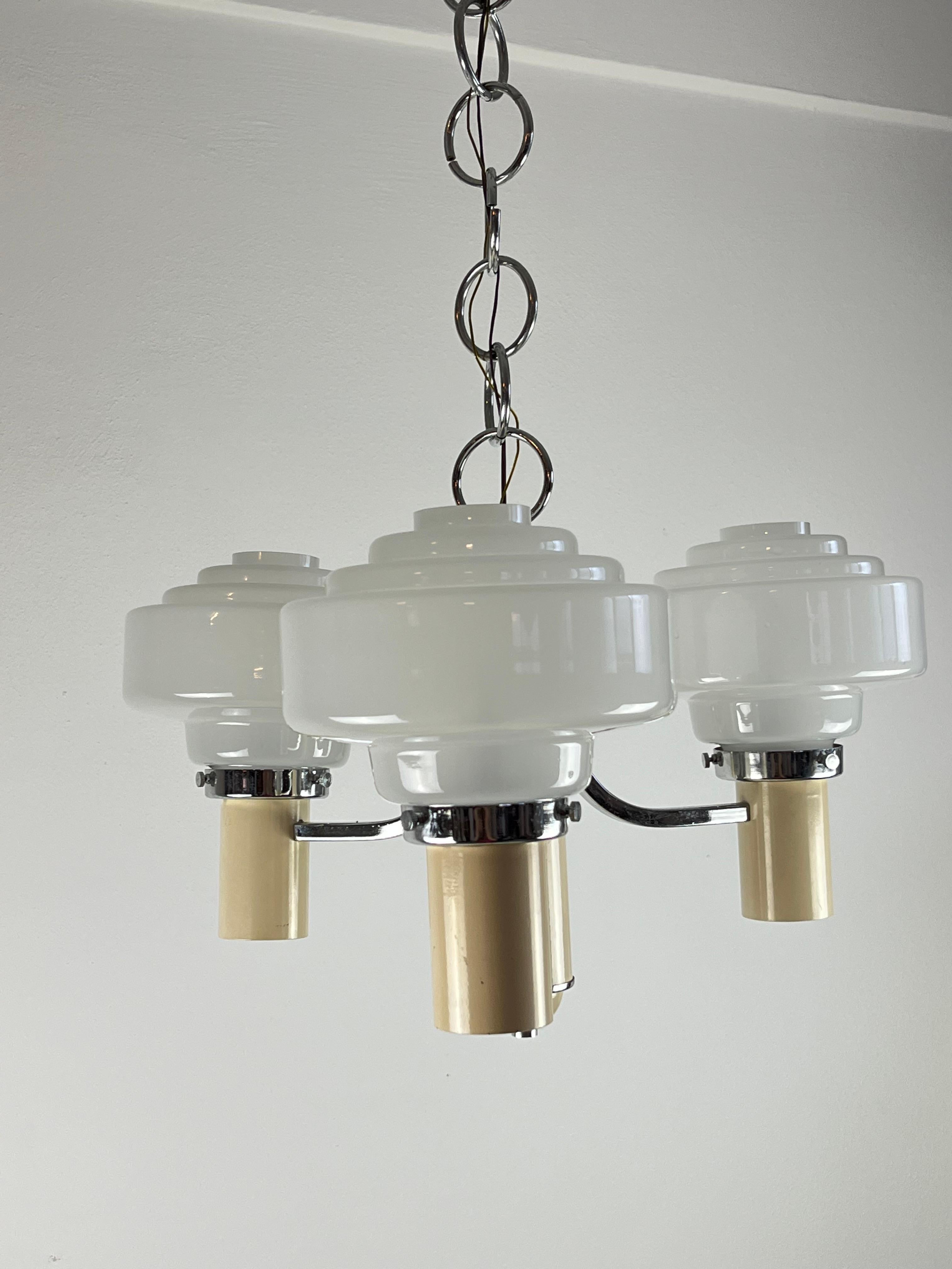 Three lights chandelier, Italy, 1970s.
In working order, small signs of ageing. Structure in chromed metal and glass bowls.Chain height included 80 cm.