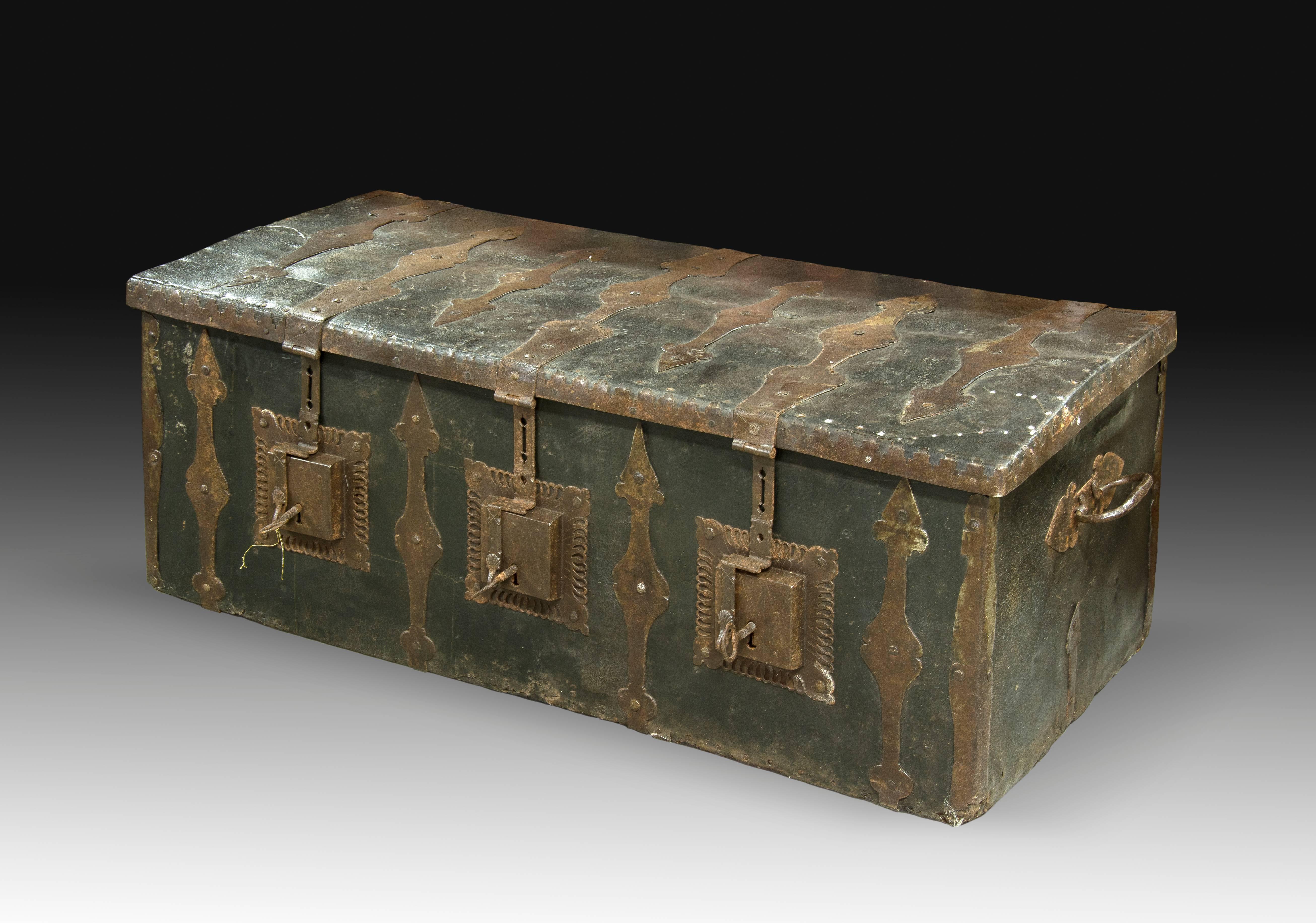 Trunk with three locks, made in wood, leather and wrought iron. This type of trunks and chest with three locks were very common in town halls. The decoration links the piece with the Baroque art.
Size: 125x48x57 cms.
International Buyers – Please